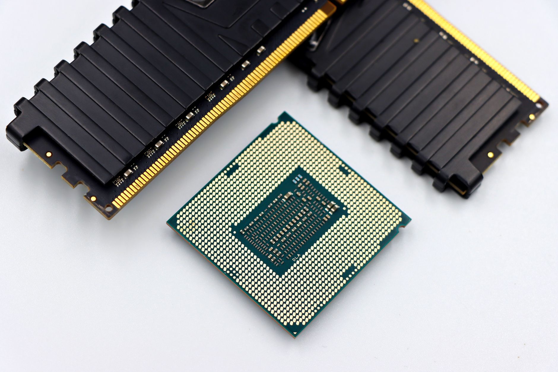 rows of compact AI inference processor chips arranged on an electronics testing board under laboratory lighting, with diagnostic equipment visible alongside
