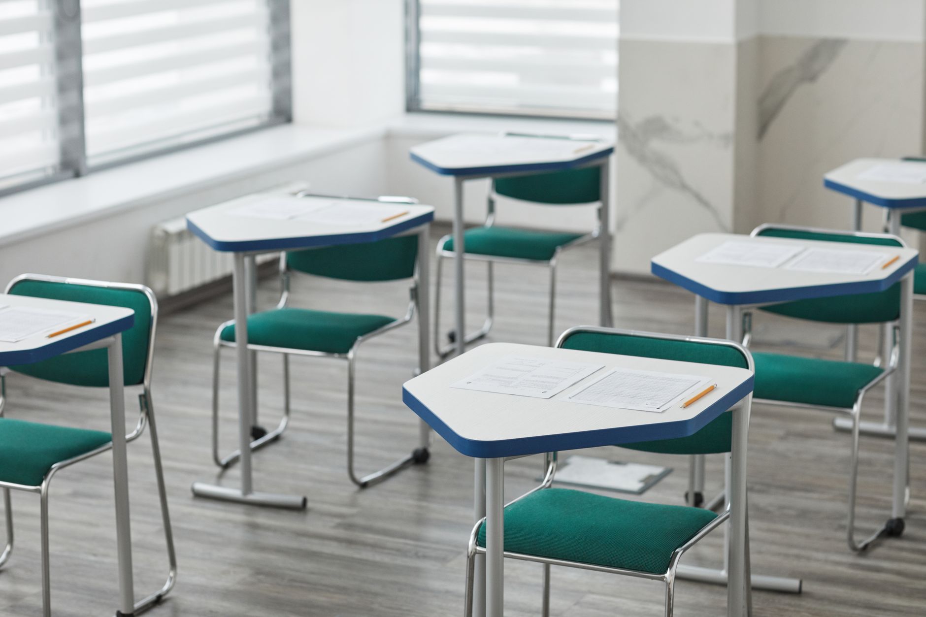 a transition assistance program classroom with empty desks, projector screen at the front showing a job readiness slide, fluorescent overhead lighting