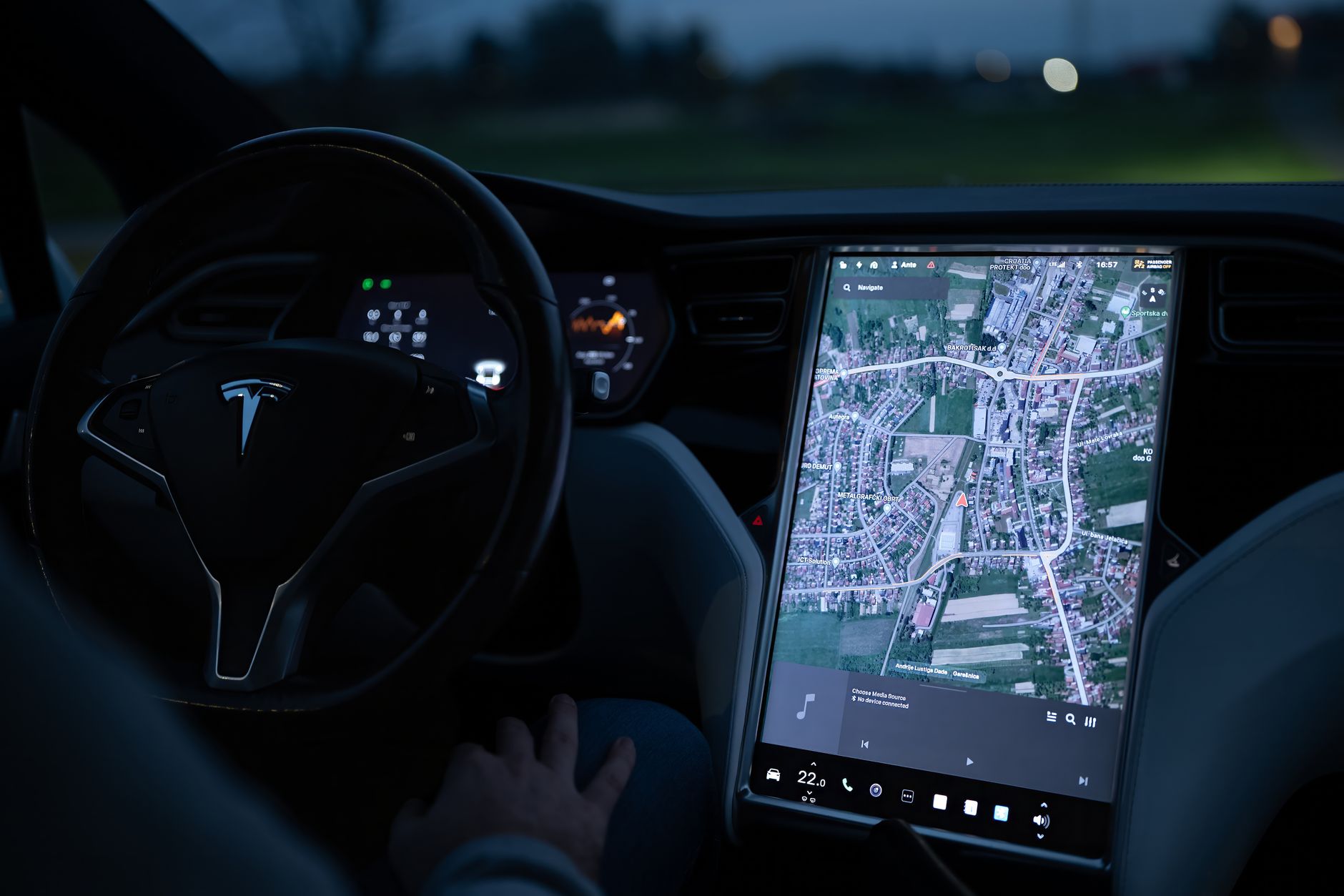 interior of an automotive technology lab with dashboard-mounted sensor arrays and large display screens showing road-mapping visualizations