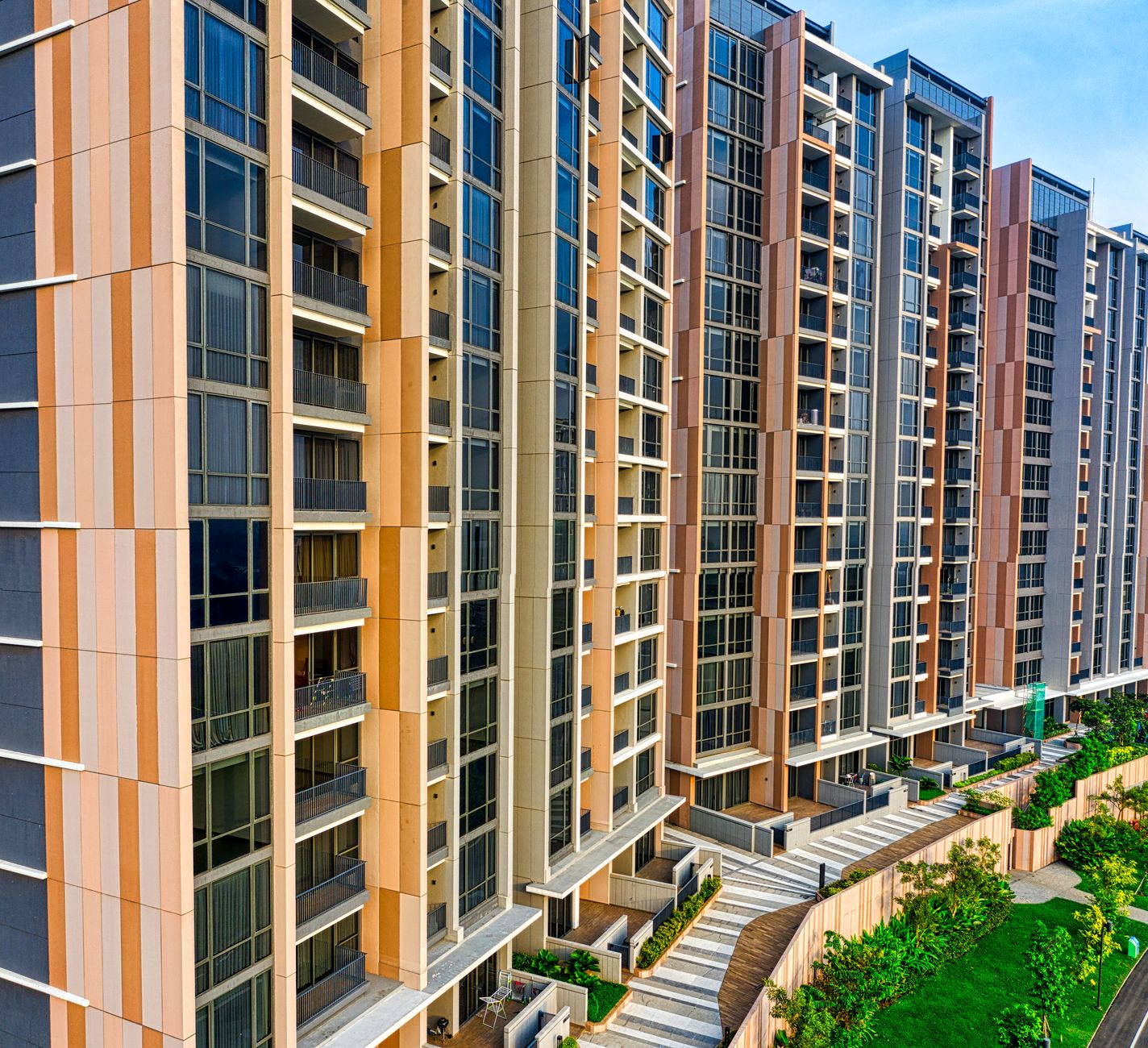exterior of a large modern apartment complex adjacent to a federal government district, wide-angle architectural shot showing the building facade, parking areas, and surrounding urban streetscape