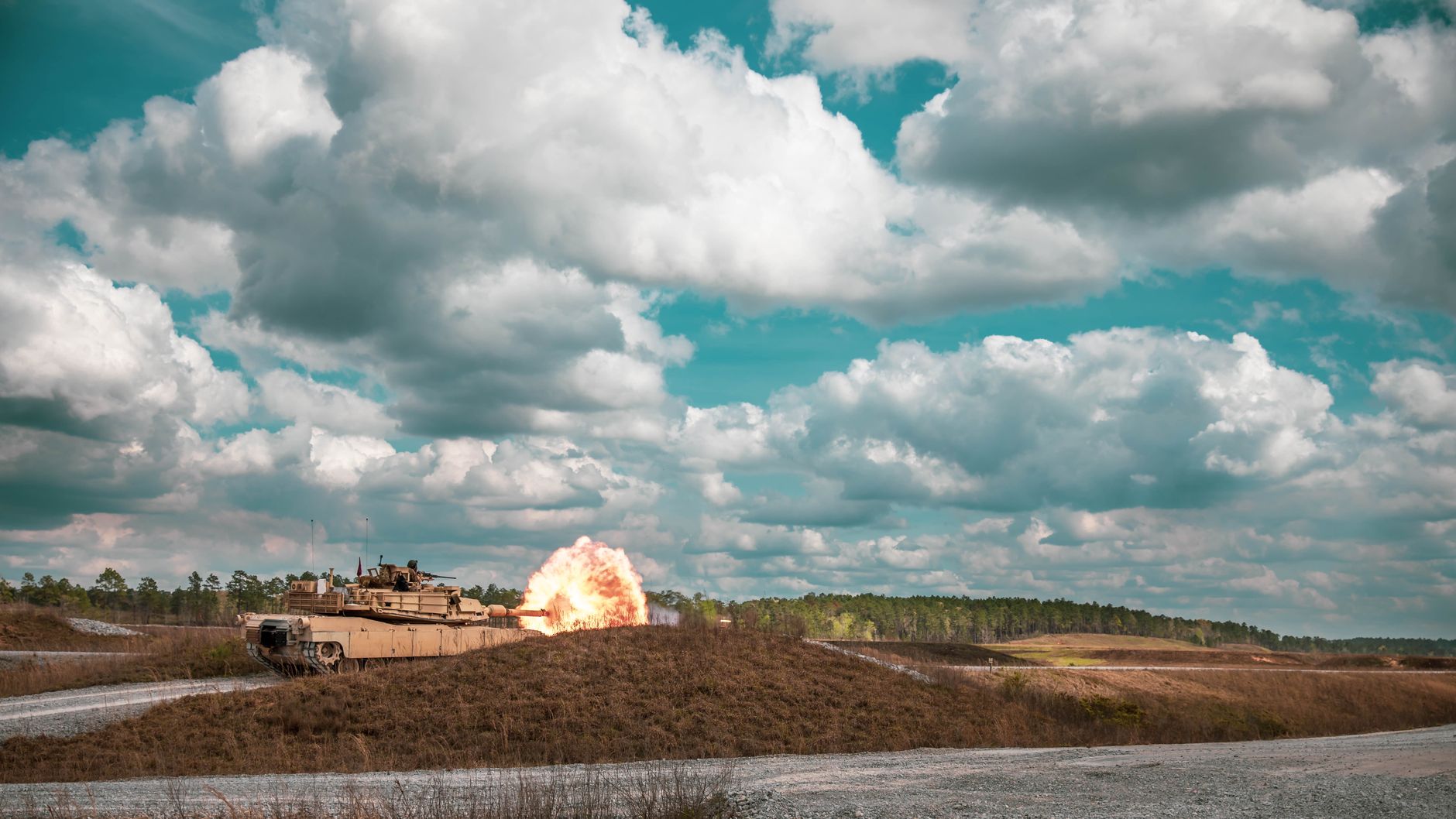 a radar antenna array mounted on a wheeled military vehicle, positioned in open terrain during a field evaluation exercise