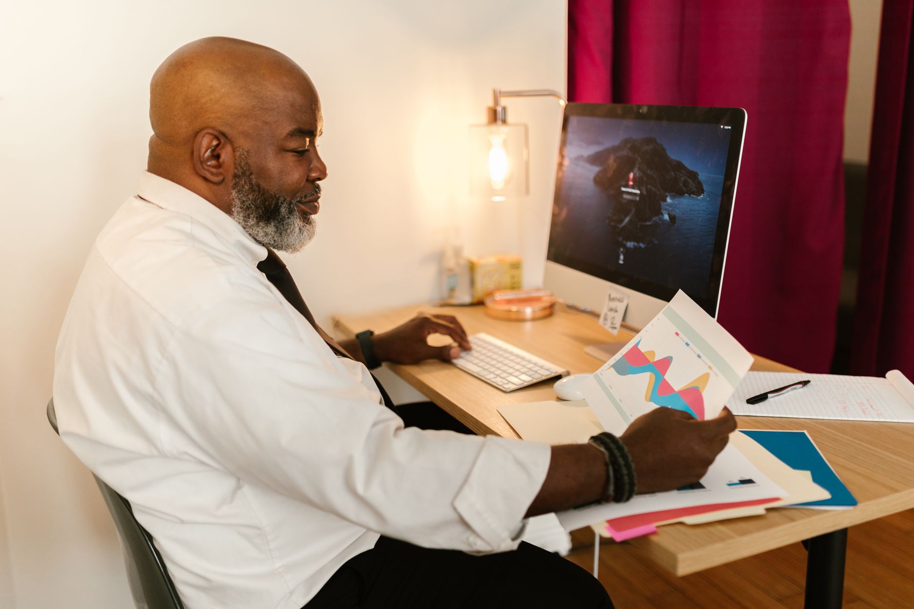 a military veteran in civilian clothing reviewing paperwork at a transportation training facility, with a large commercial truck visible through the window behind the desk area