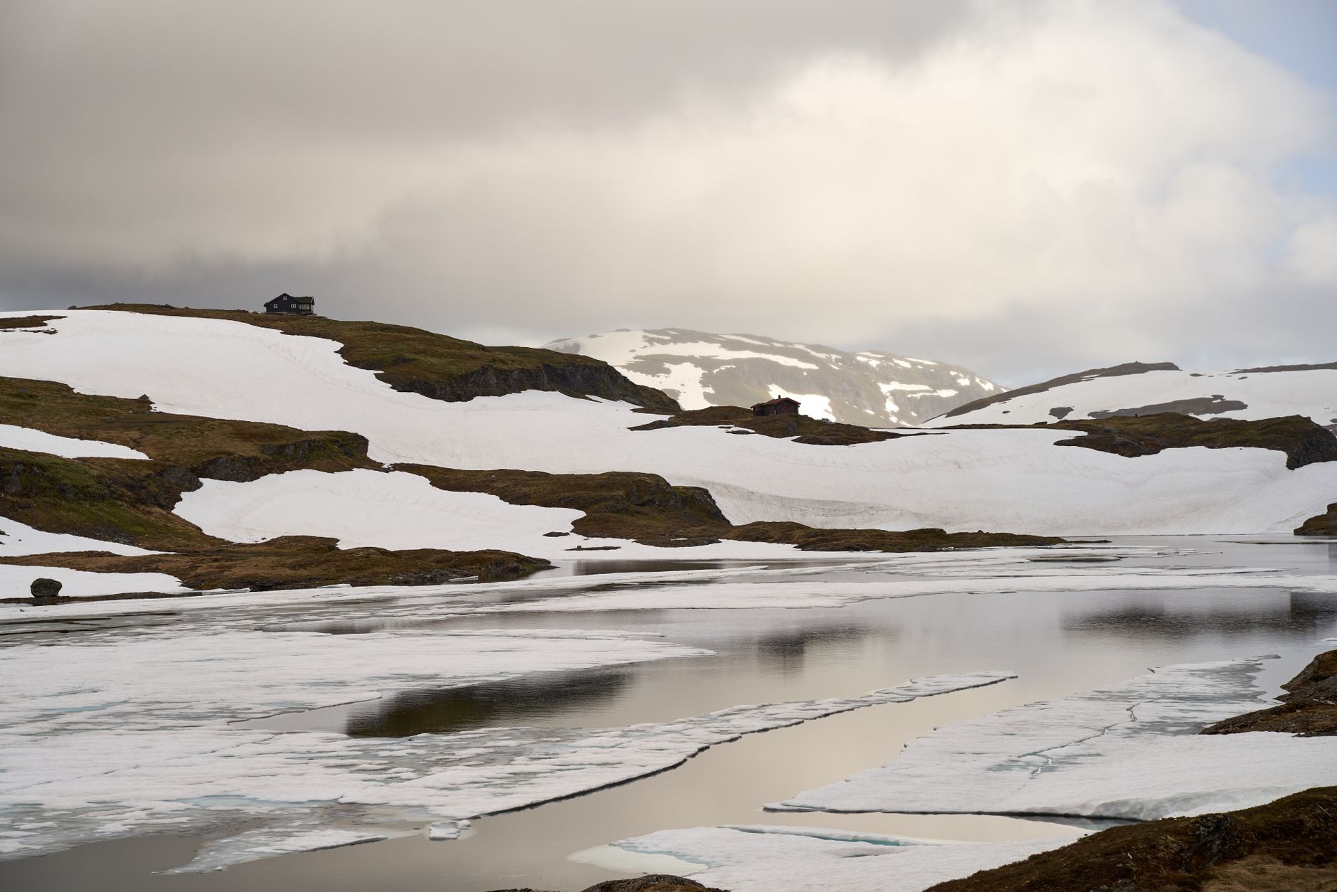 aerial view of a remote Arctic coastal radar installation with antenna arrays and support structures surrounded by tundra and ice