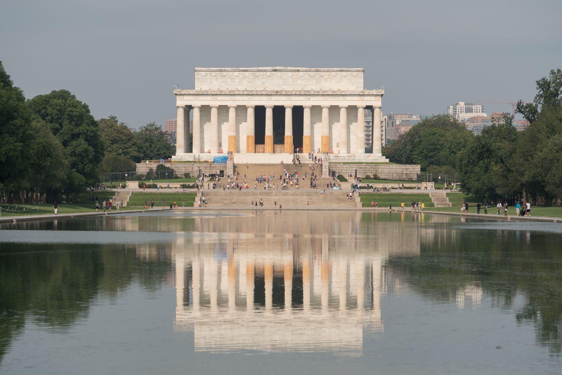 rows of folding chairs and temporary command post structures set up on the grounds near the Capitol Reflecting Pool, with security staging equipment visible in the background