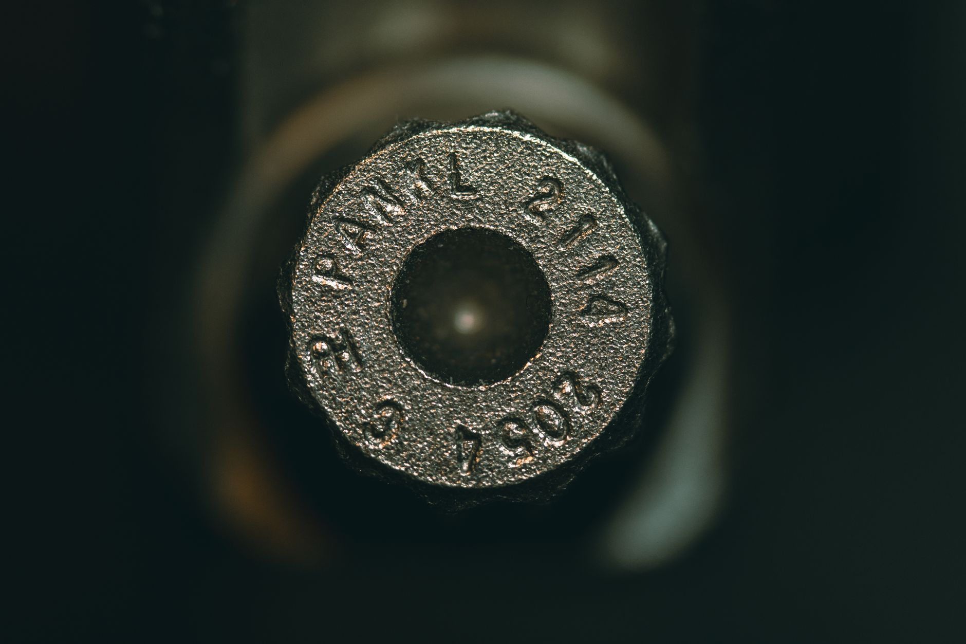 close-up of specialty small-caliber ammunition cartridges arranged on a flat surface in a testing environment, with neutral industrial background