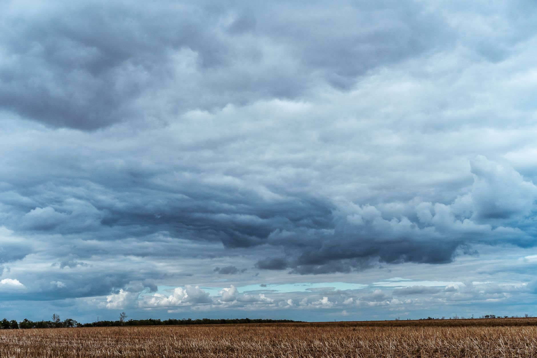 A wide shot of a Ukrainian air defense radar installation in an open field, with antenna arrays visible against an overcast sky