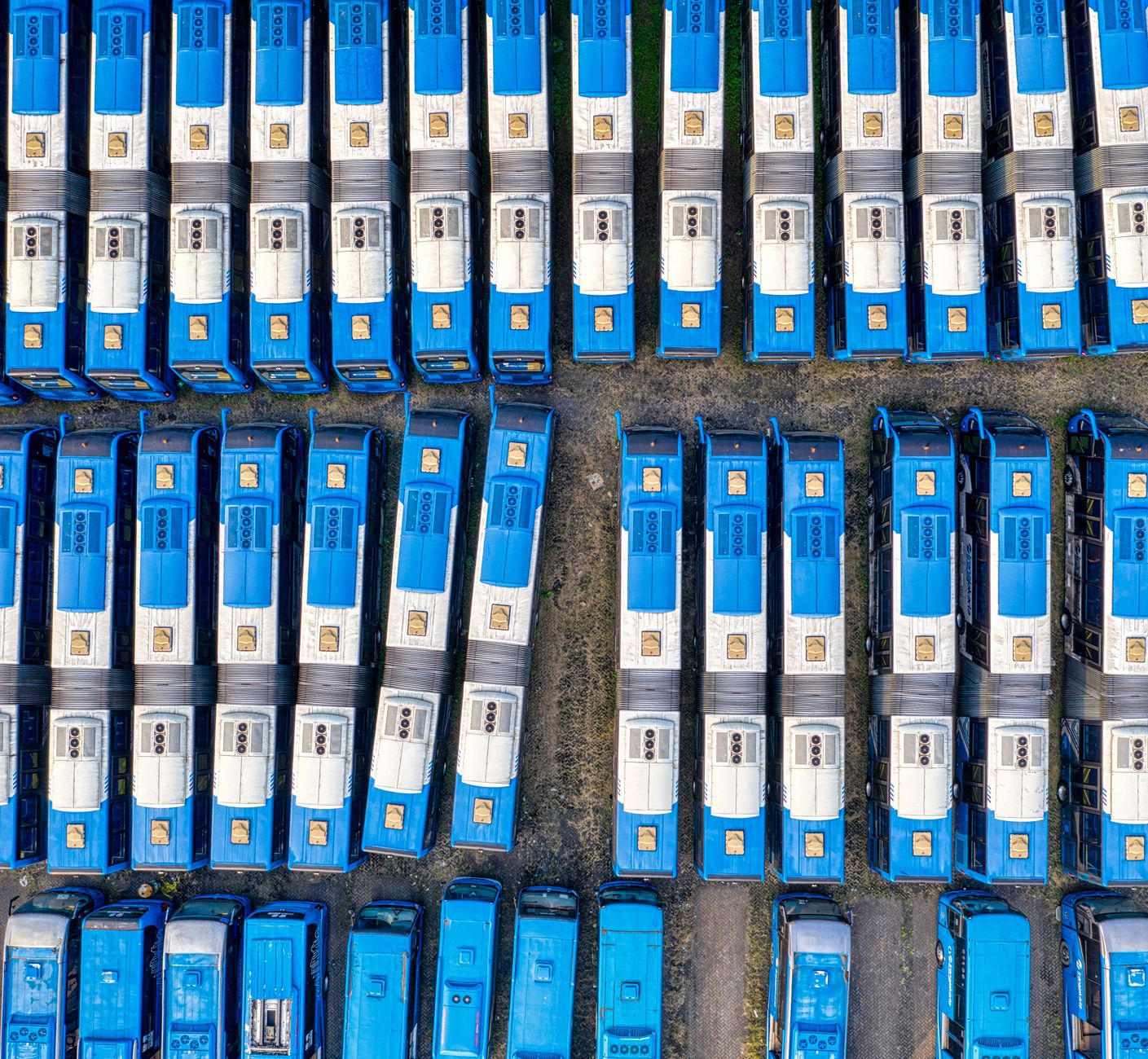 Rows of mobile ballistic missile transporter-erector-launchers parked inside a large covered vehicle depot