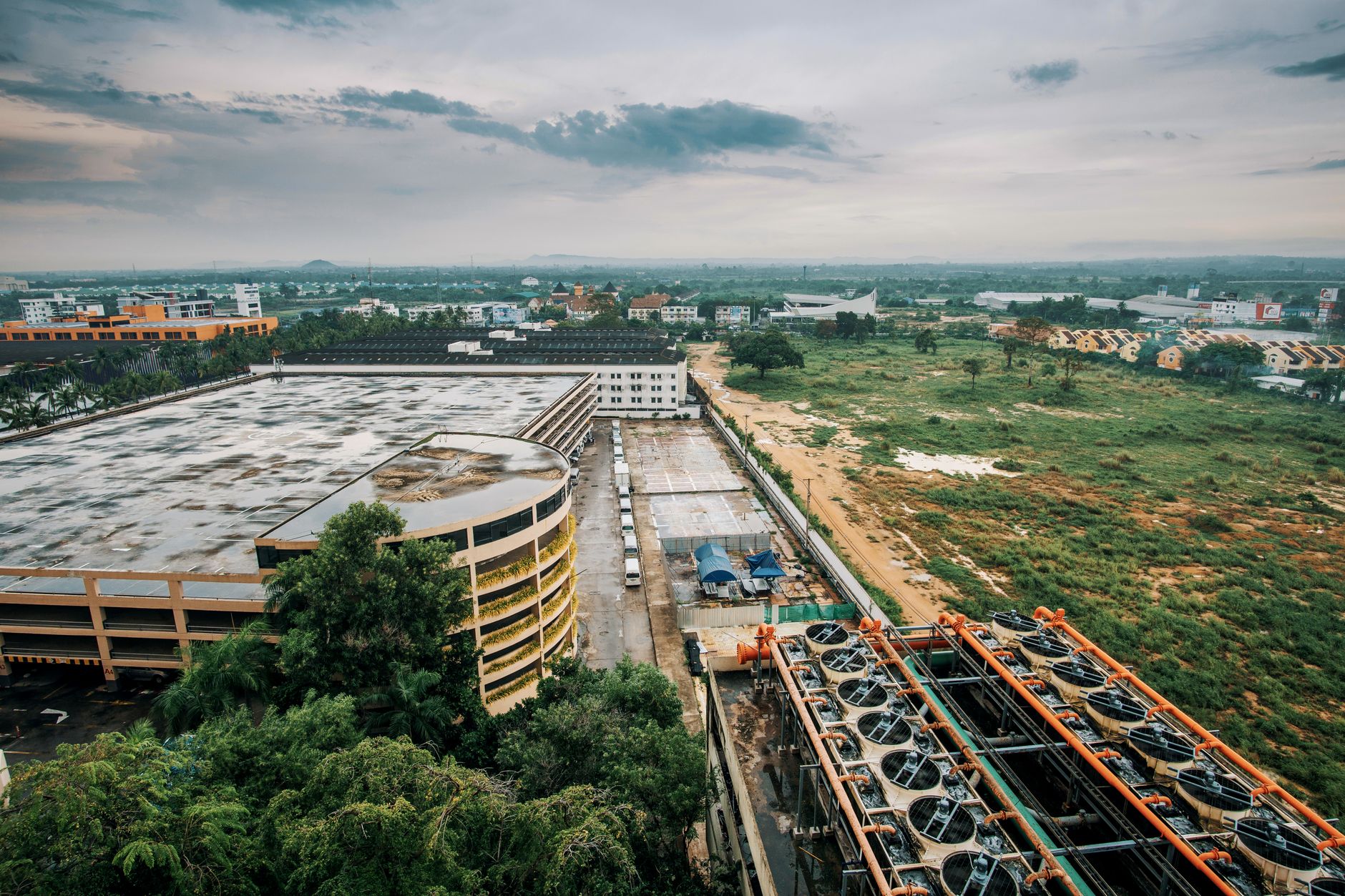 an aerial view of a large modern defense ministry complex with administrative buildings and secure perimeter fencing, no people in foreground