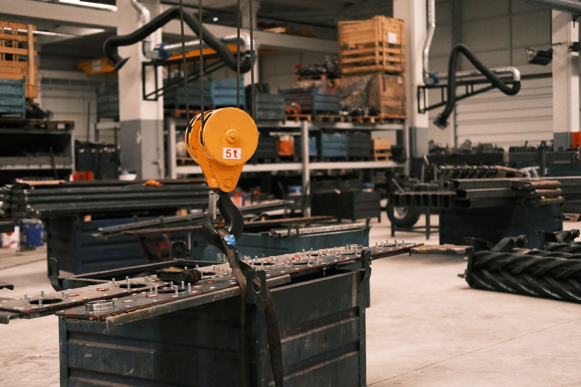 rows of assembled unmanned aerial vehicles inside a large industrial production hangar, machinery and assembly equipment visible in background