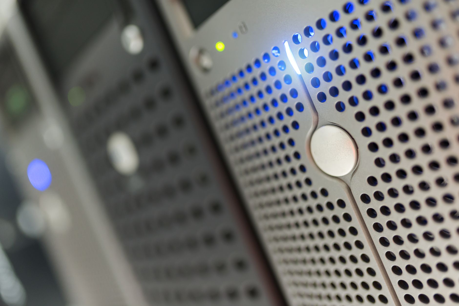 a server room with rows of illuminated data racks inside a modern technology facility, no people visible