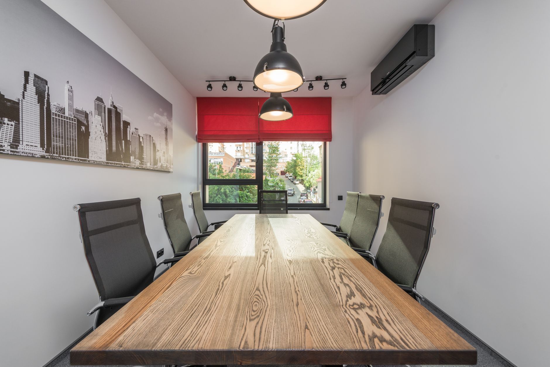 a formal law office conference room with floor-to-ceiling windows overlooking a city skyline, empty chairs around a long table with legal documents and binders visible