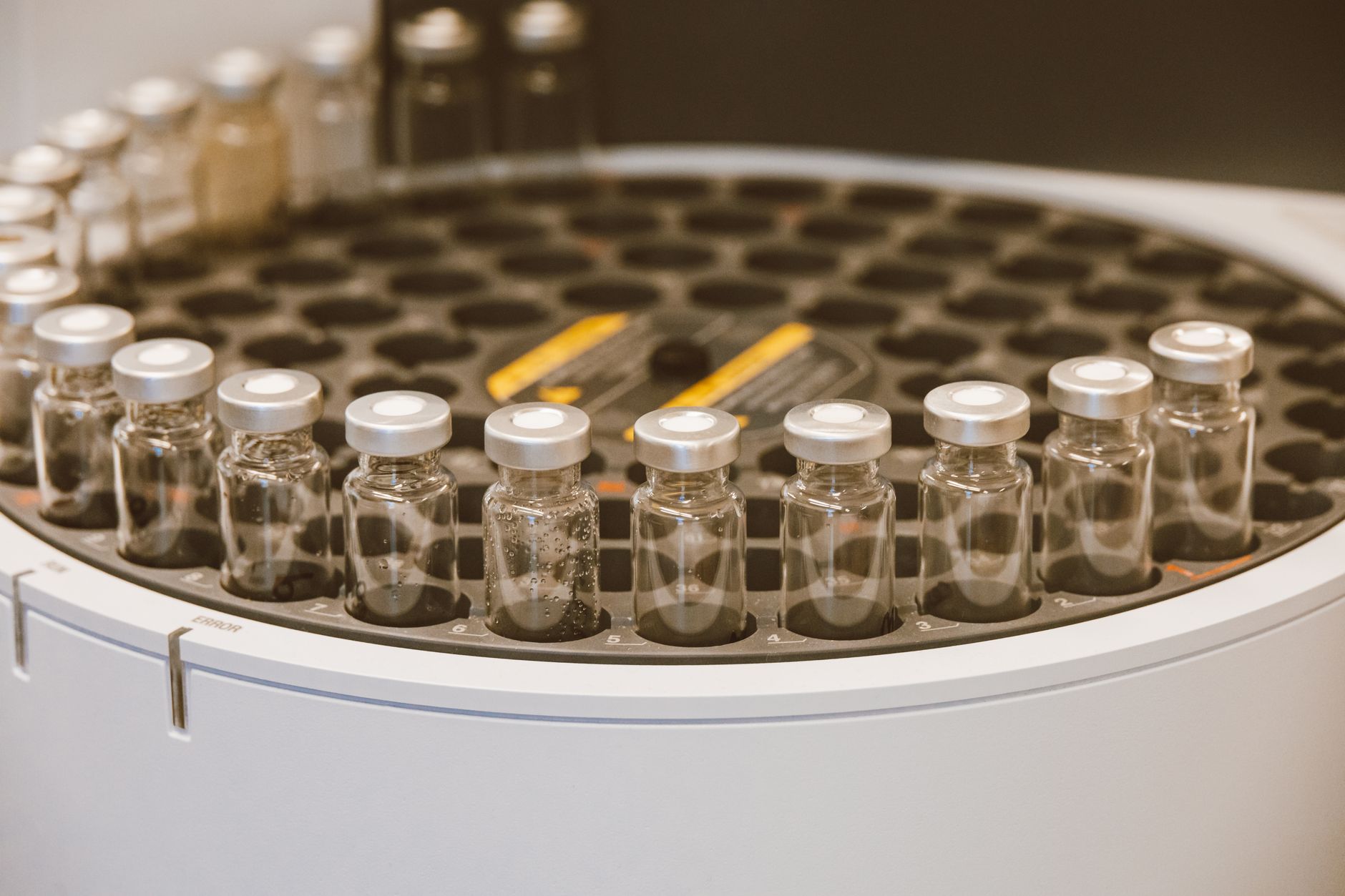 rows of 5.56mm rifle cartridges arranged on a laboratory testing surface inside a ballistics research facility
