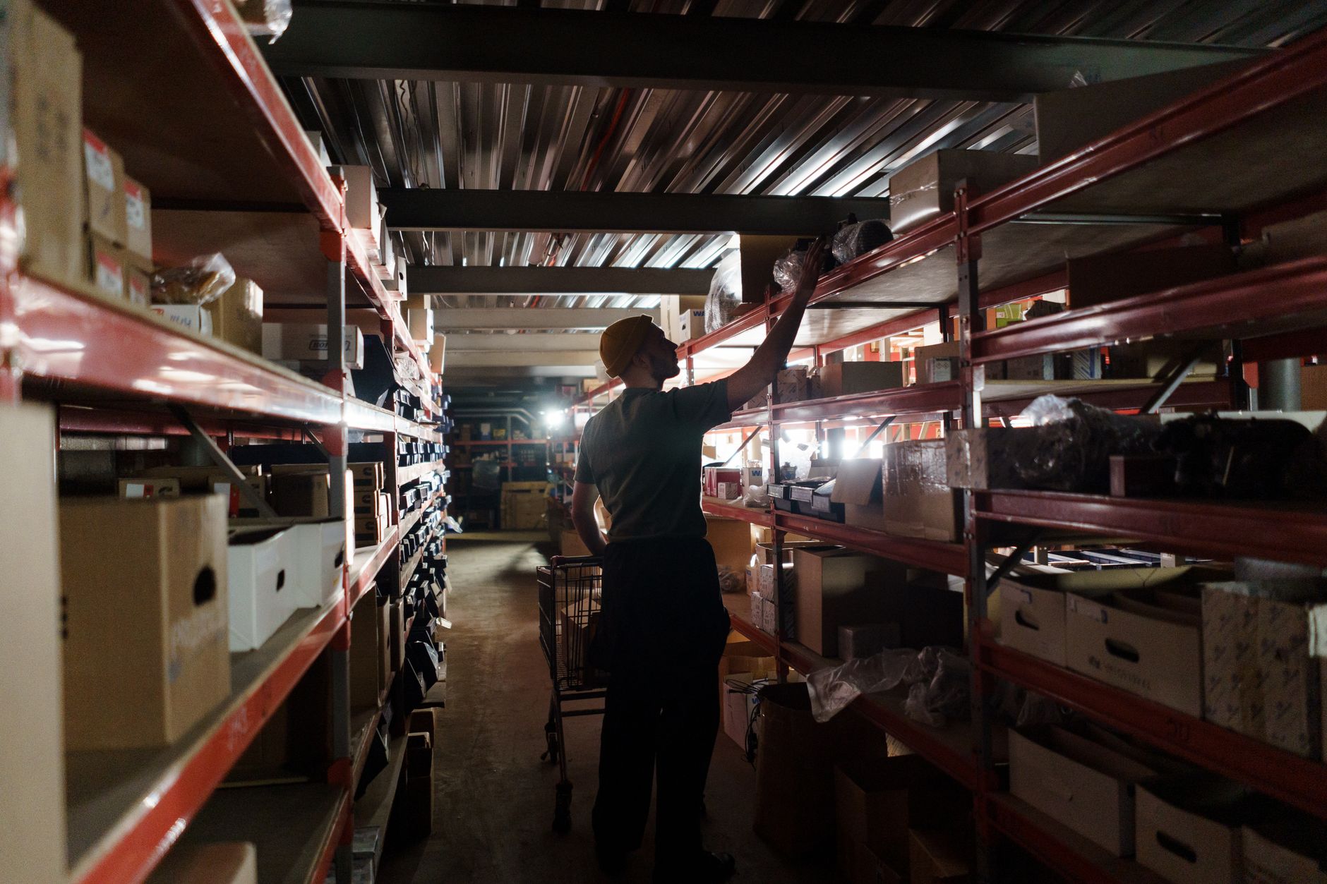 rows of MANPADS launcher tubes and associated munitions arranged on shelving inside a Polish defense production facility, no people as focal point