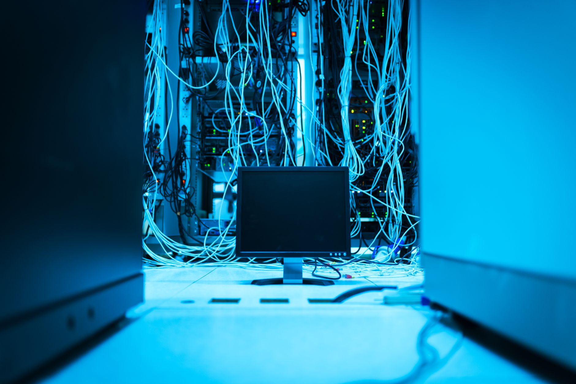 rows of high-density server racks inside a large enterprise cloud computing facility, with cable management systems and cooling infrastructure visible throughout the aisle