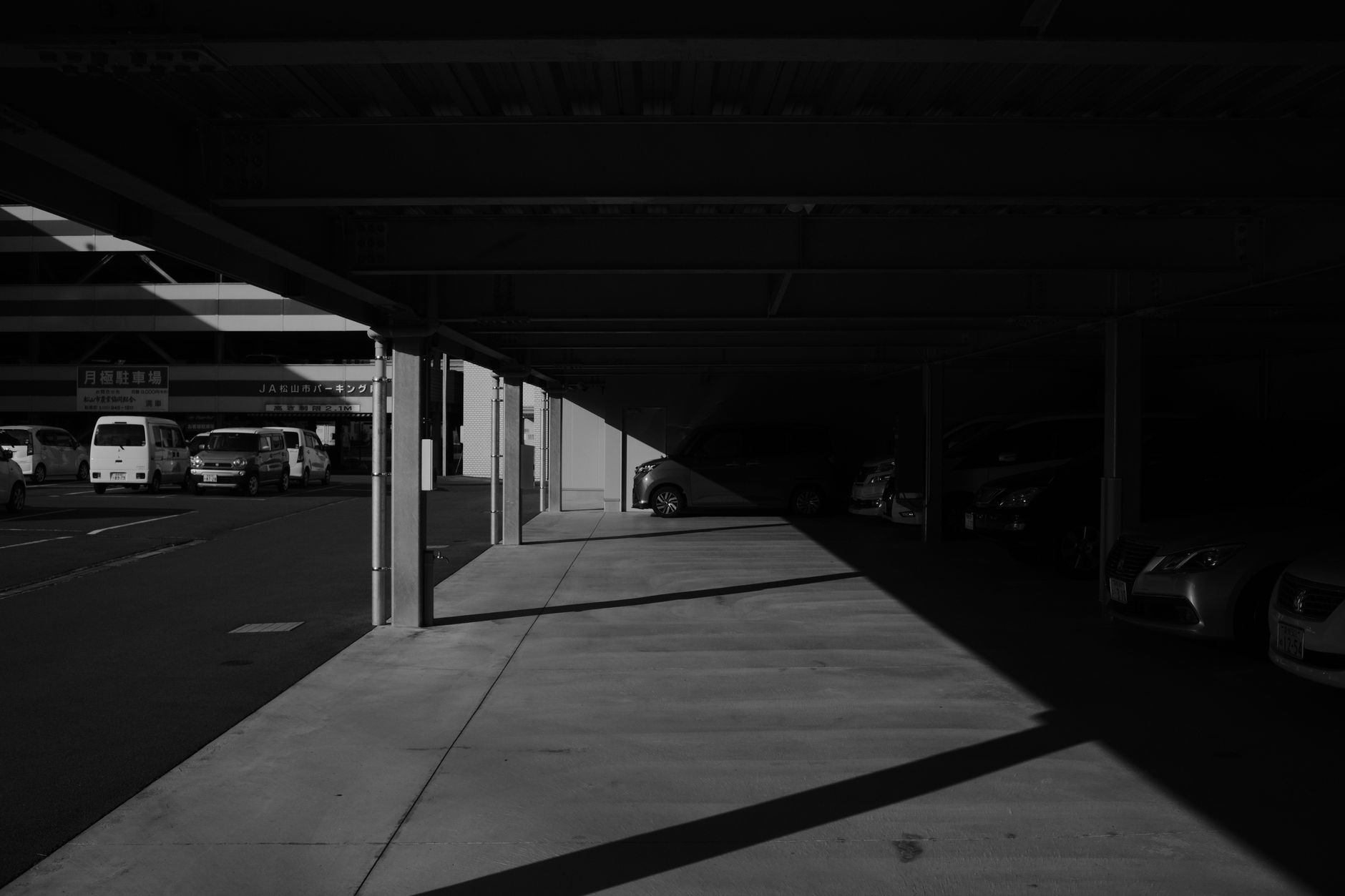 a long-range ballistic missile on a mobile transporter-erector-launcher parked inside a cavernous industrial facility, viewed from a wide angle with overhead lighting casting shadows across the vehicle's frame