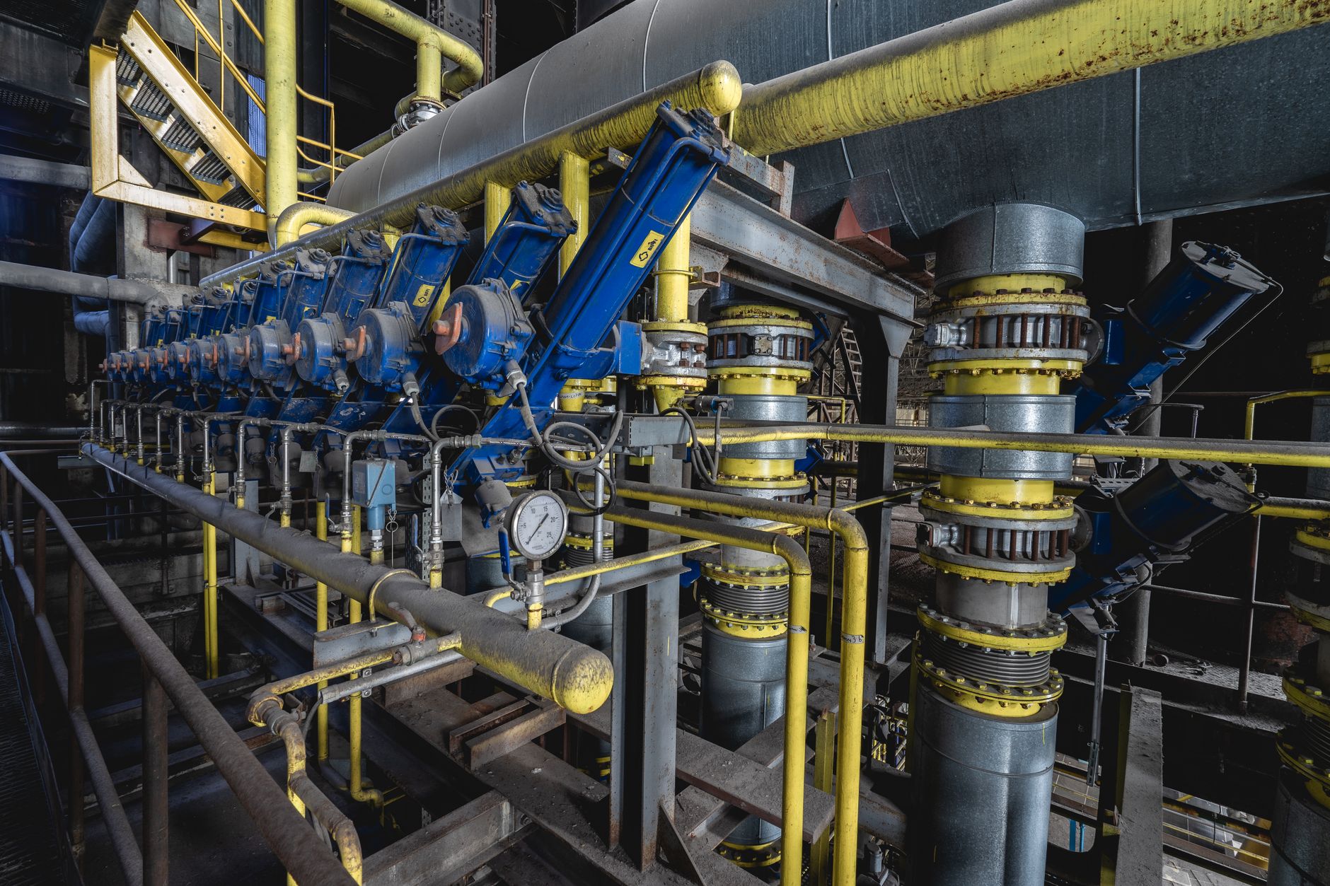 interior of a rare-earth element processing plant showing industrial furnaces and conveyor equipment in an American manufacturing facility, no personnel as focal point