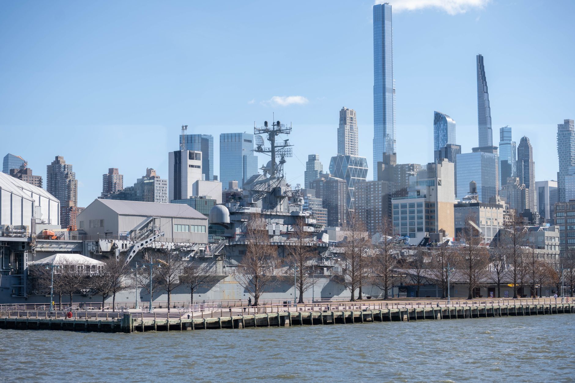 an AN/SPY-6 radar array mounted on a U.S. Navy destroyer's mast, photographed from the pier at a naval installation during daylight