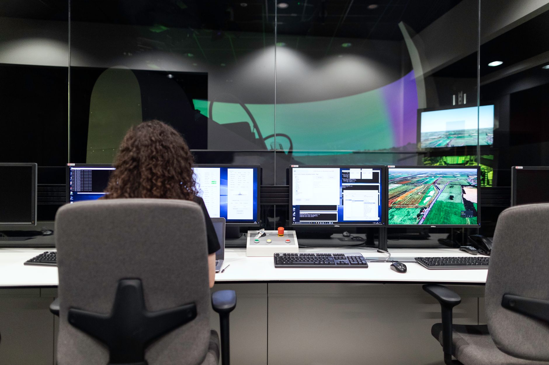 rows of administrative military personnel workstations inside a Department of Defense benefits processing office, with computer monitors and file organizers visible
