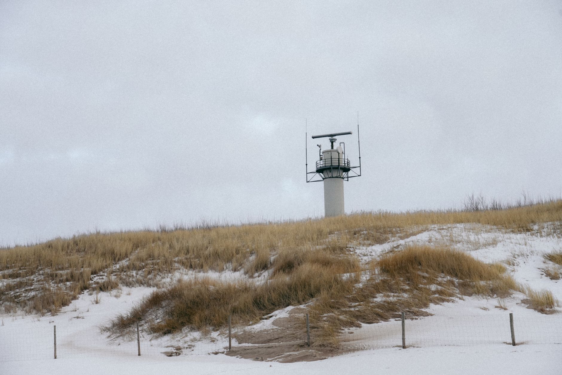 a surface-to-air missile battery system on a military test range surrounded by open terrain, with radar and command vehicles visible in the background