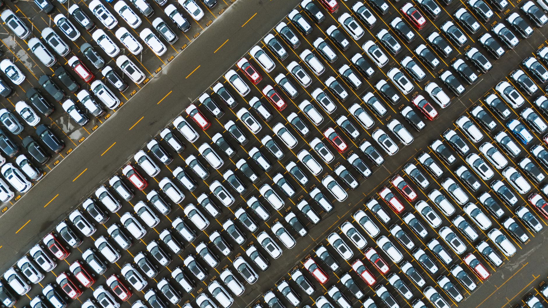 rows of South Korean and U.S. military vehicles parked on a large outdoor tarmac at a joint base, viewed from a wide elevated angle showing the full extent of the staging area
