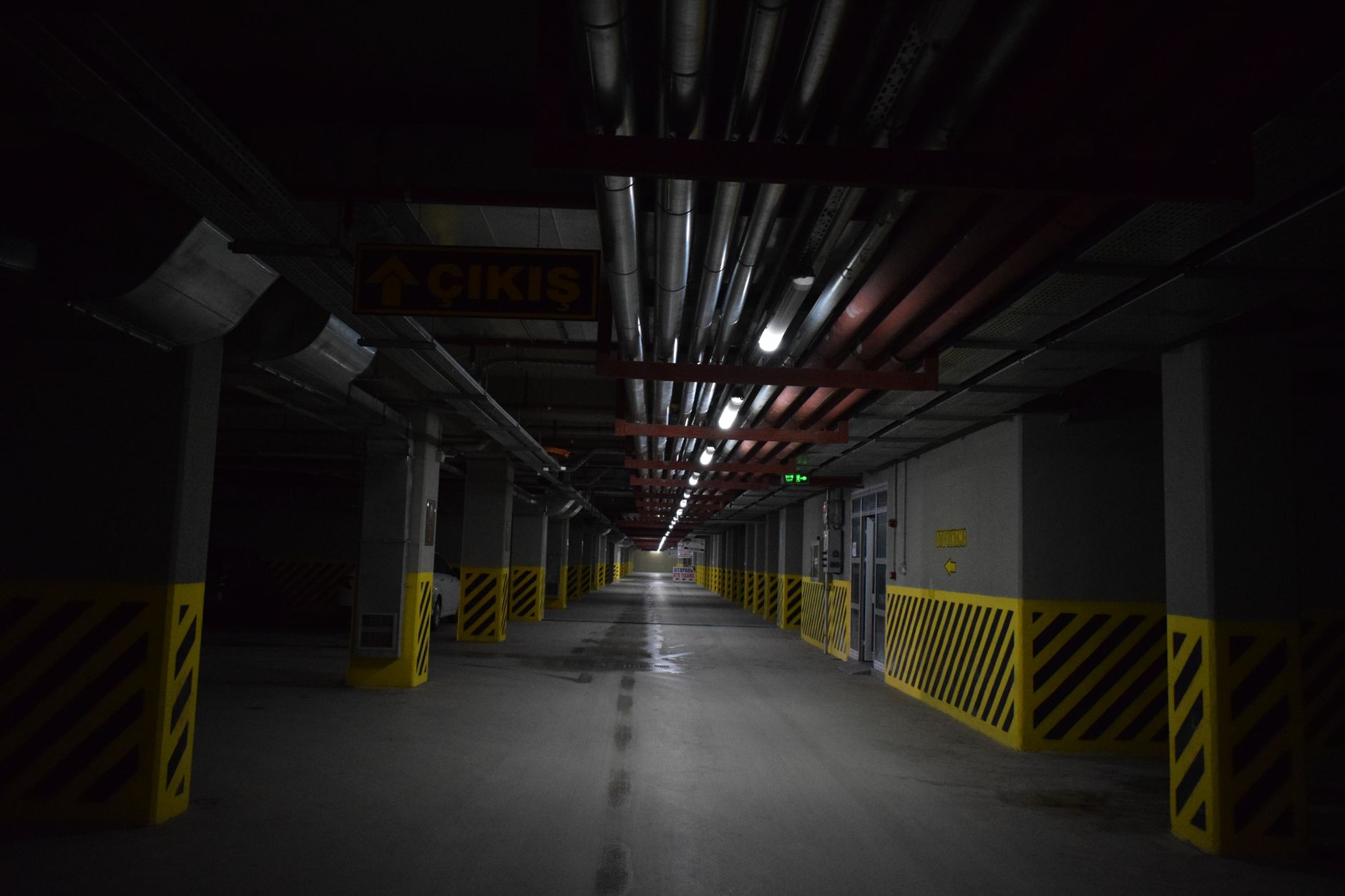 rows of ground-based missile interceptor canisters inside a large military storage and maintenance facility, overhead lighting, no personnel as focal point