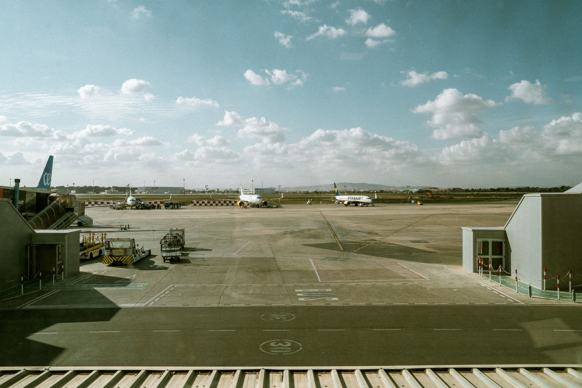 wide shot of a military air base flight line in Israel, with parked jet aircraft visible under desert-light conditions, ground support equipment in the foreground