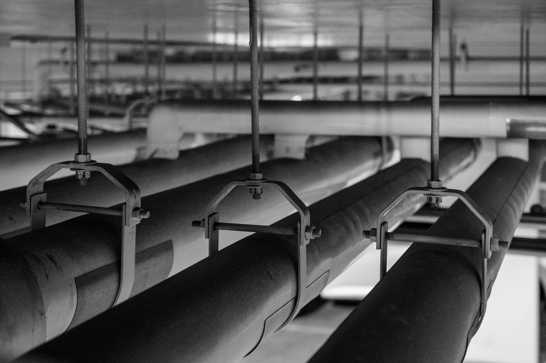 the interior of a naval destroyer's engine room, showing large propulsion machinery, piping systems, and dim industrial lighting, with no personnel as the focal point