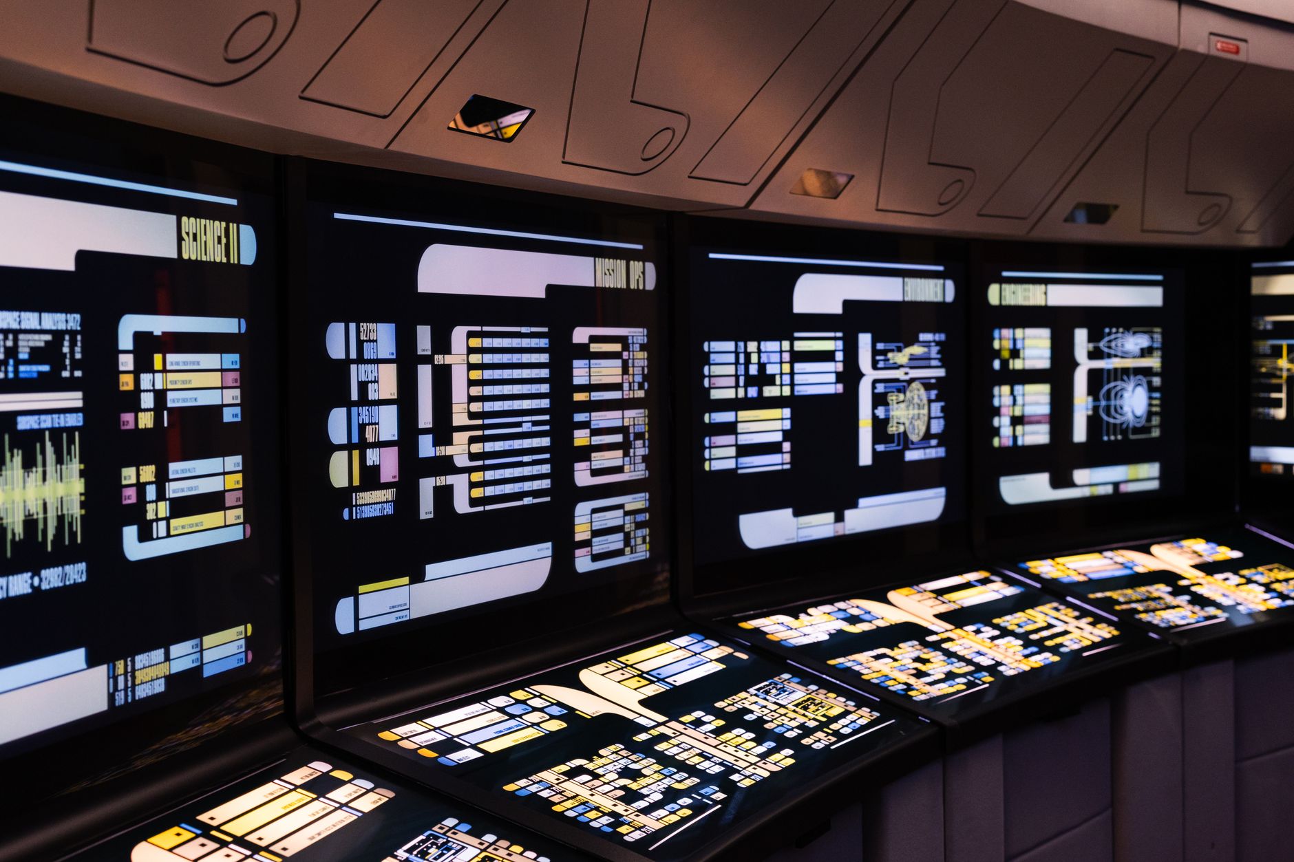 interior of a modern military command center with large digital display screens showing airspace maps and aircraft tracking data, equipment visible but no personnel as focal point