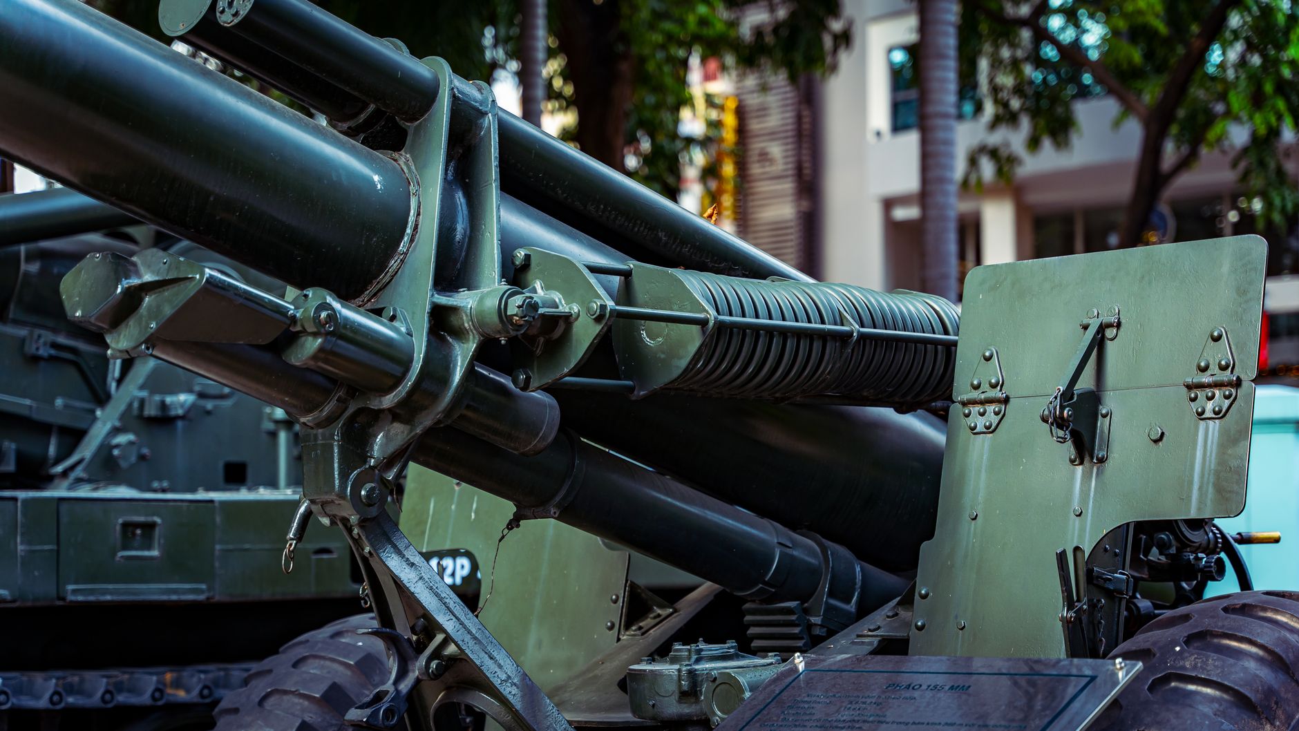 exterior view of a ground-based air defense launcher system positioned in an open test range environment, surrounded by low terrain and sensor equipment