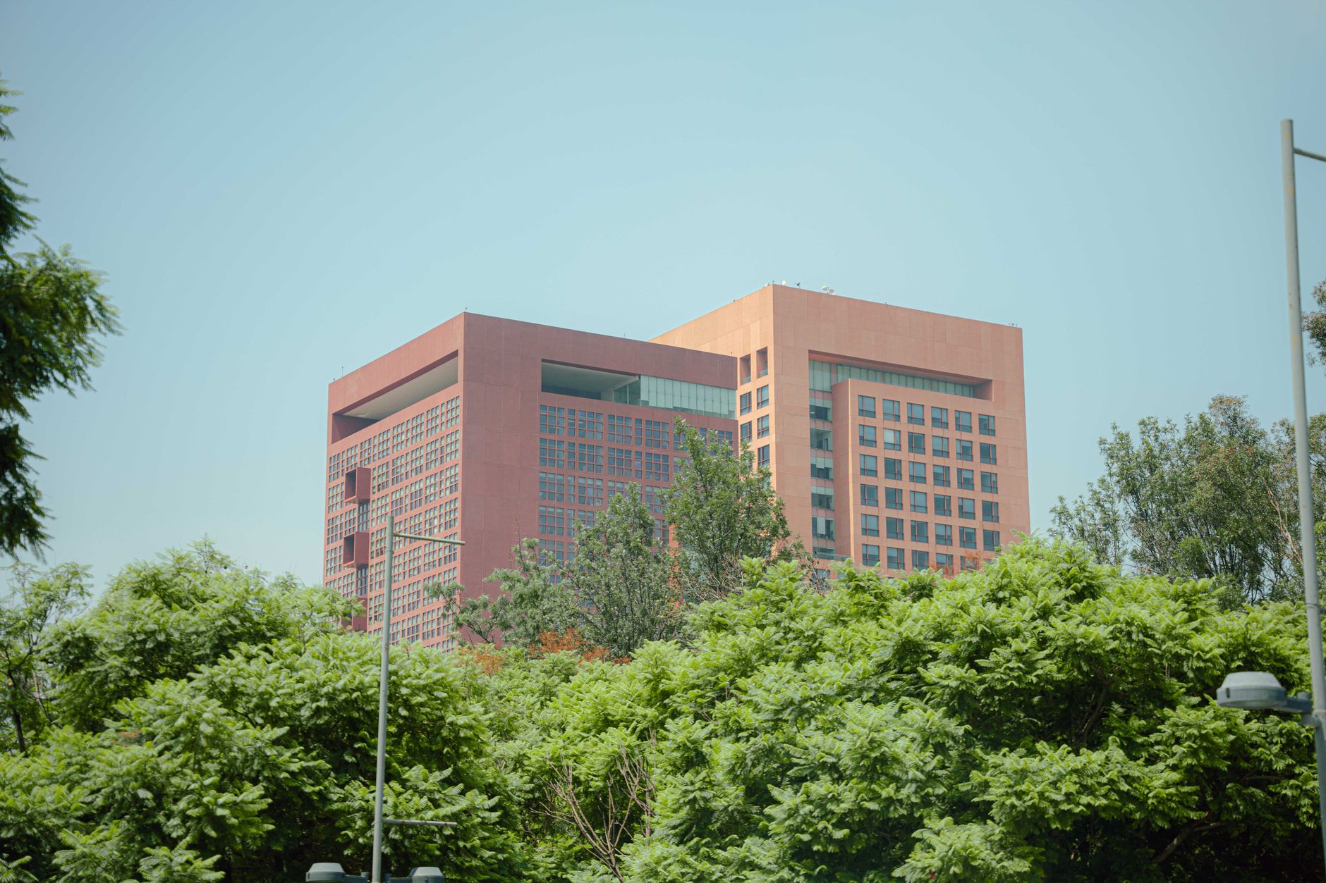 exterior of a modern government cybersecurity operations facility, showing a nondescript office building with federal signage in a suburban campus setting