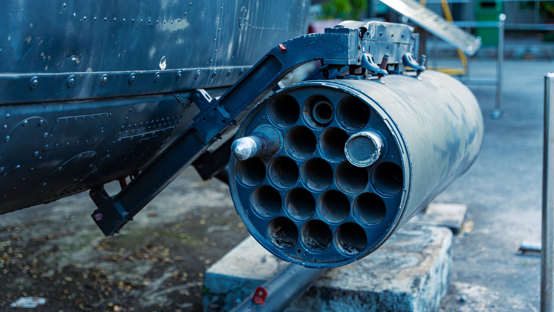 a mobile Spyder launcher unit on a paved military installation, missile canisters elevated, surrounded by communications equipment and support vehicles