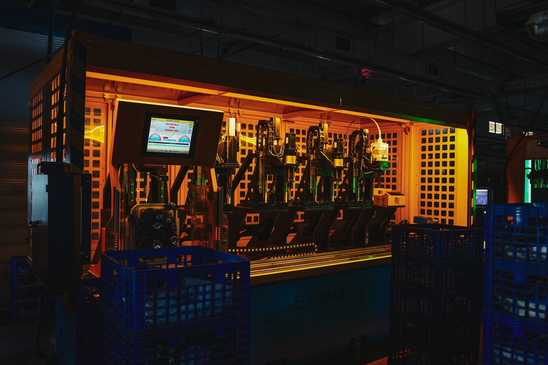 an industrial defense manufacturing floor with drone airframe components arranged on assembly benches inside a modern production facility
