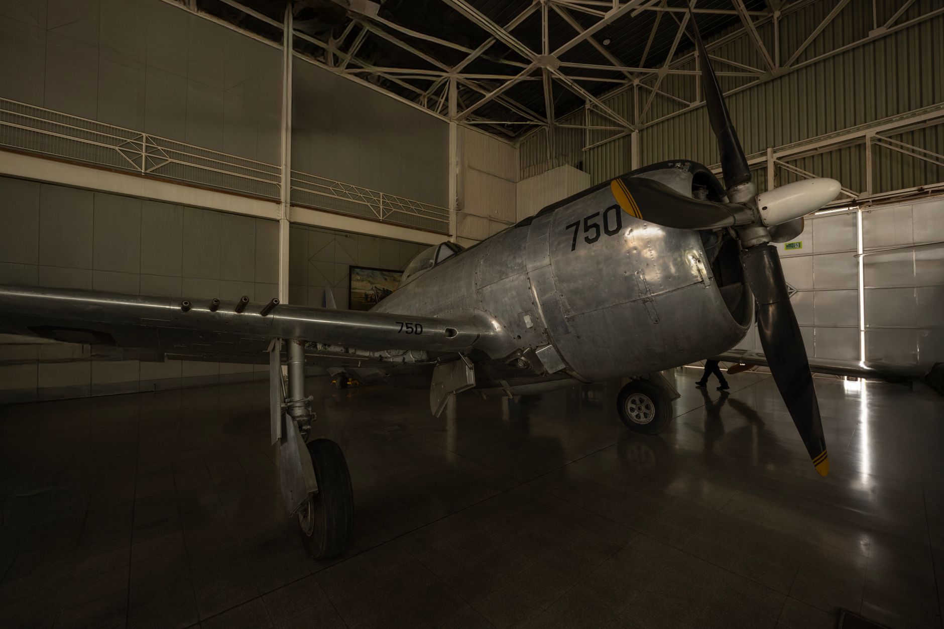 a scale model of a sixth-generation combat aircraft displayed in a conference exhibition hall, with technical specification panels visible in the background