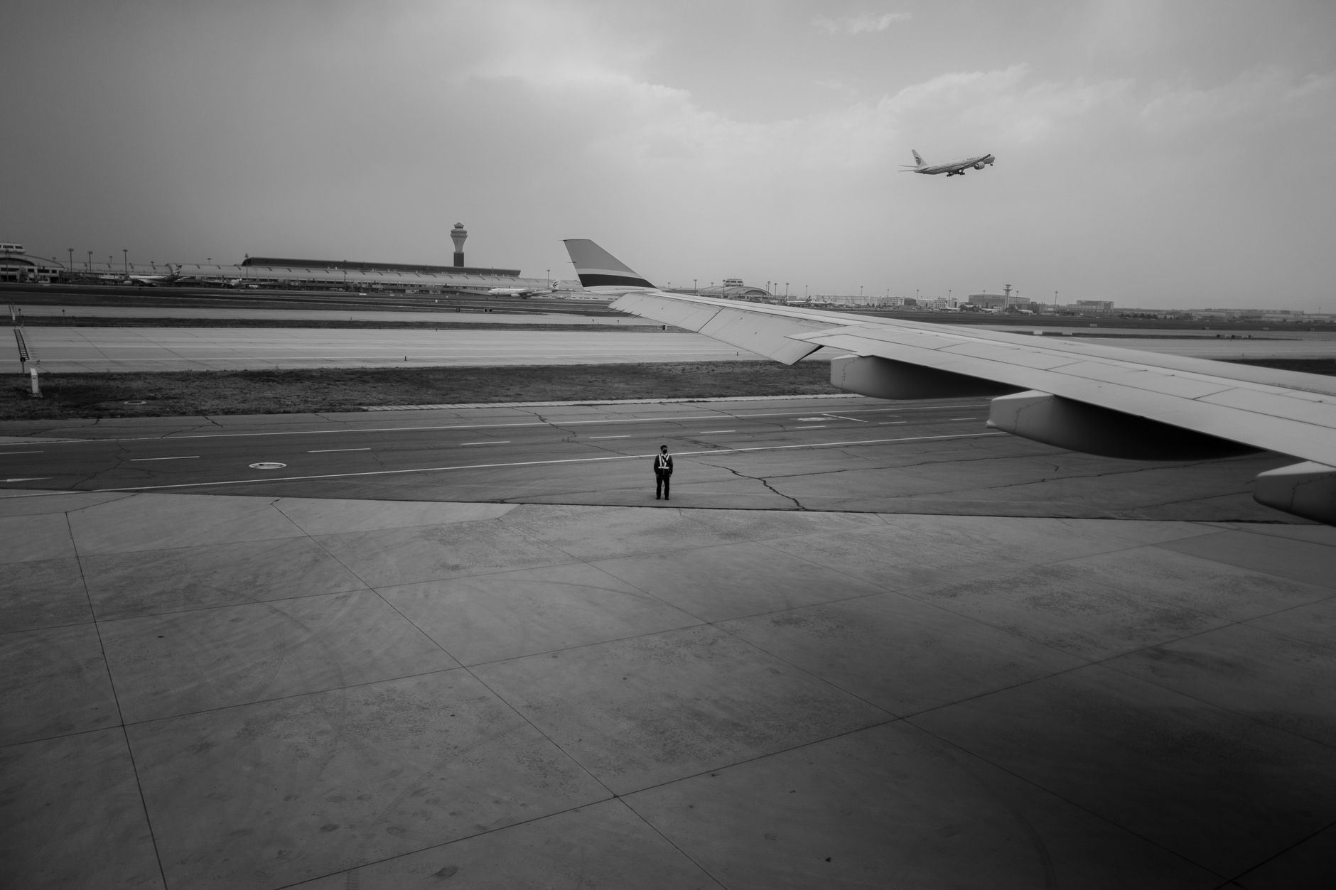 a U.S. Air Force B-1B Lancer strategic bomber on a flight line at a desert air base, ground crew vehicles visible nearby on the tarmac