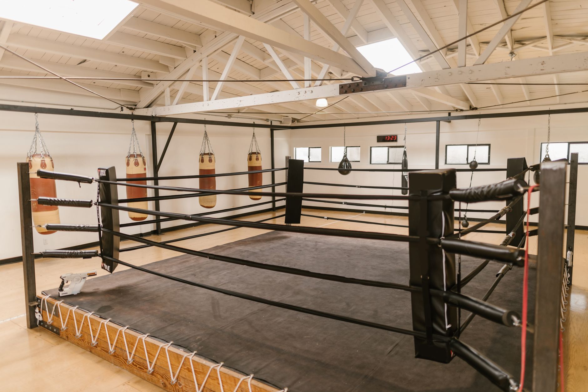 interior of a professional sports training facility showing a padded practice field with blocking sleds and coaching equipment, no people as focal point
