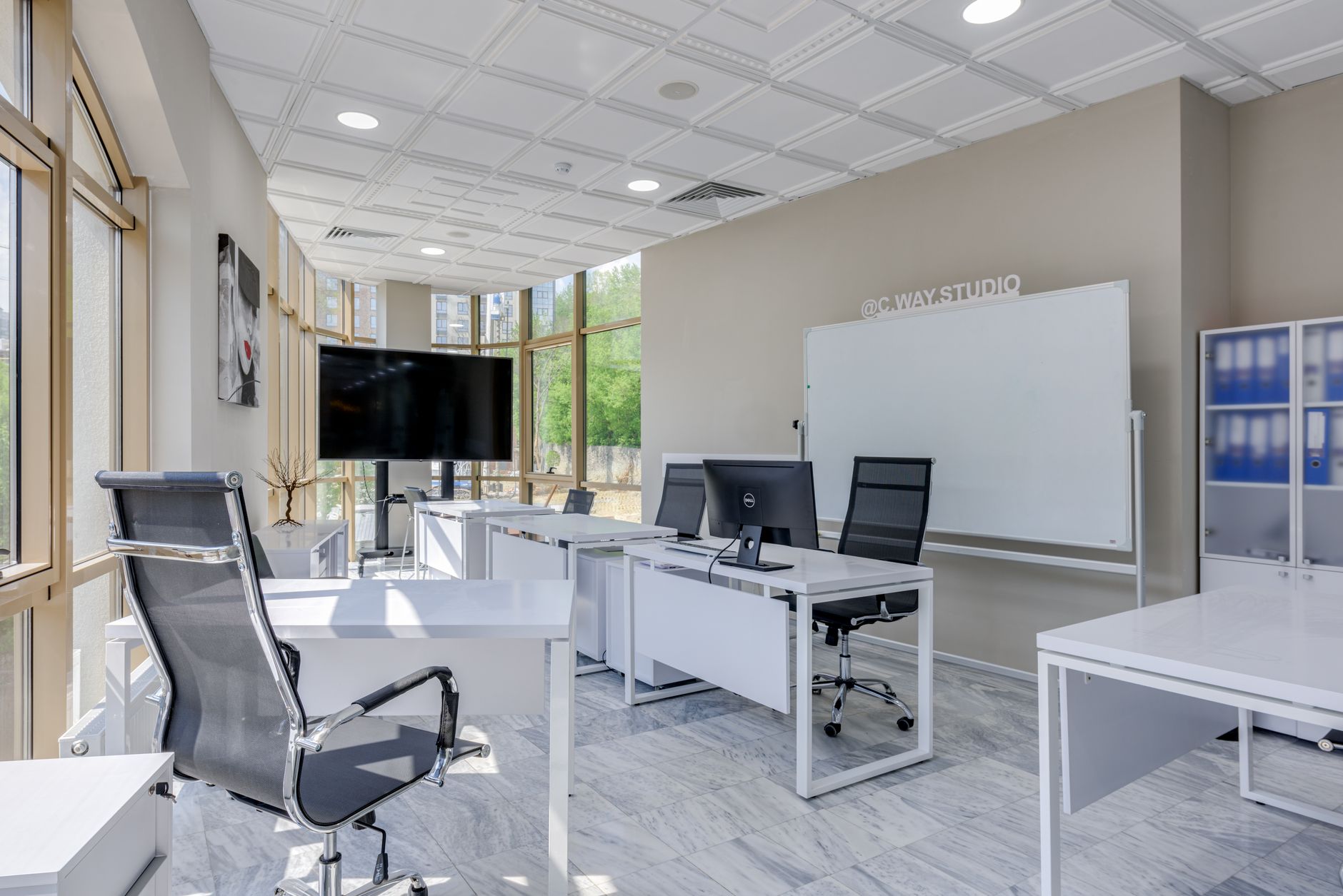 a modern military family support center on an Air Force base, with a resource bulletin board and computer workstations visible in a bright, organized office environment