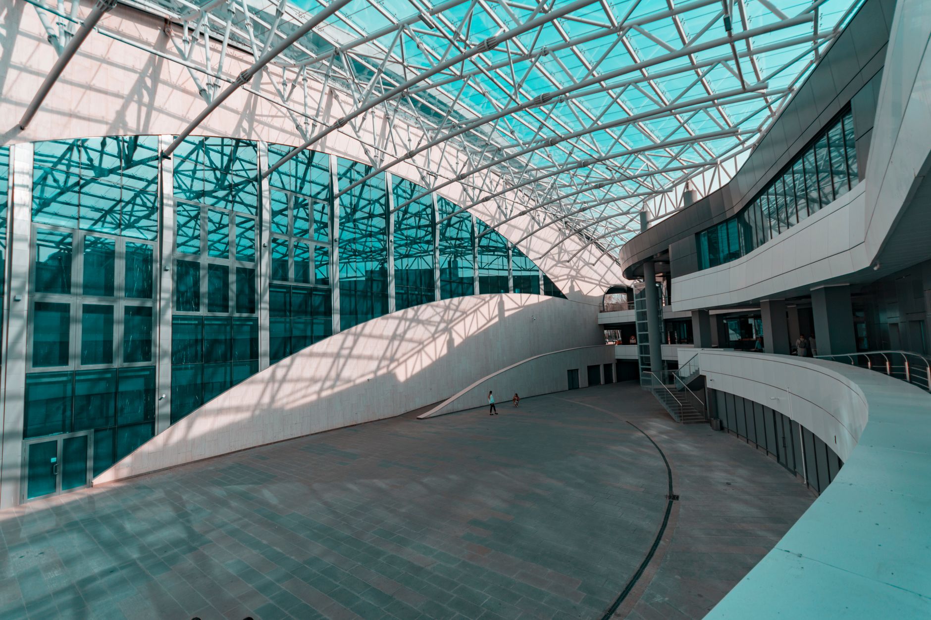 a wide-angle view of a military installation job fair venue, with rows of informational tables and signage set up inside a large indoor facility, no individuals as focal point