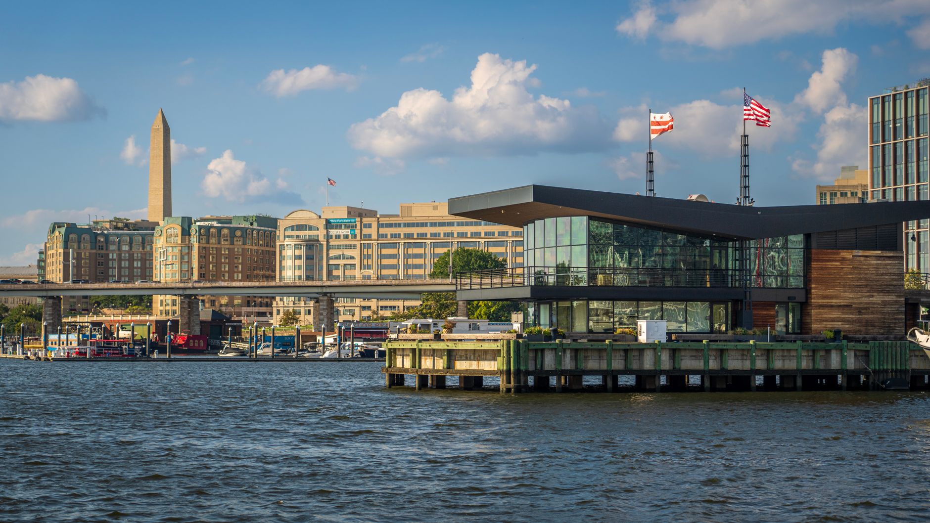 a wide shot of the Pentagon's exterior facade along the Potomac River, midday light, no people prominently featured