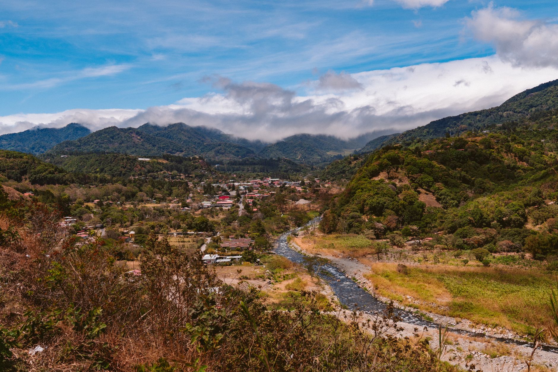 aerial view of a remote jungle river valley and coastline typical of Central American geography, shot from high altitude with no personnel visible