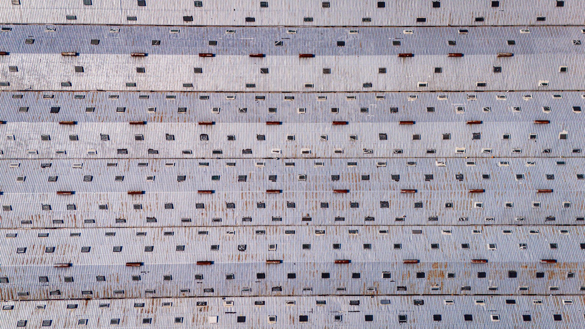 aerial view of a large industrial manufacturing complex with loading docks and warehouses in a snow-dusted Russian industrial zone