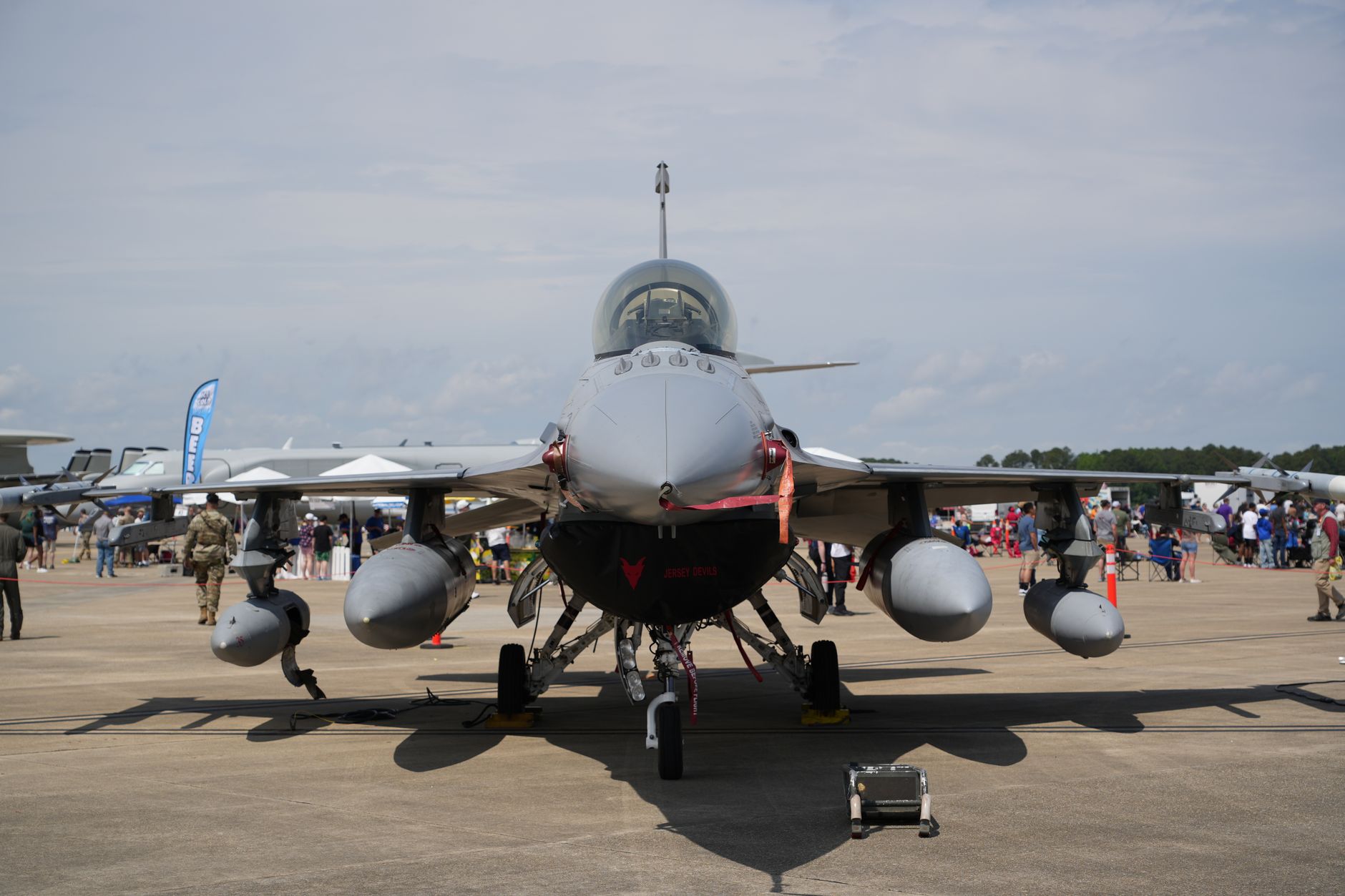 a Rampage air-launched missile mounted beneath the wing of a combat aircraft on a tarmac during a static display, surrounded by ground crew equipment
