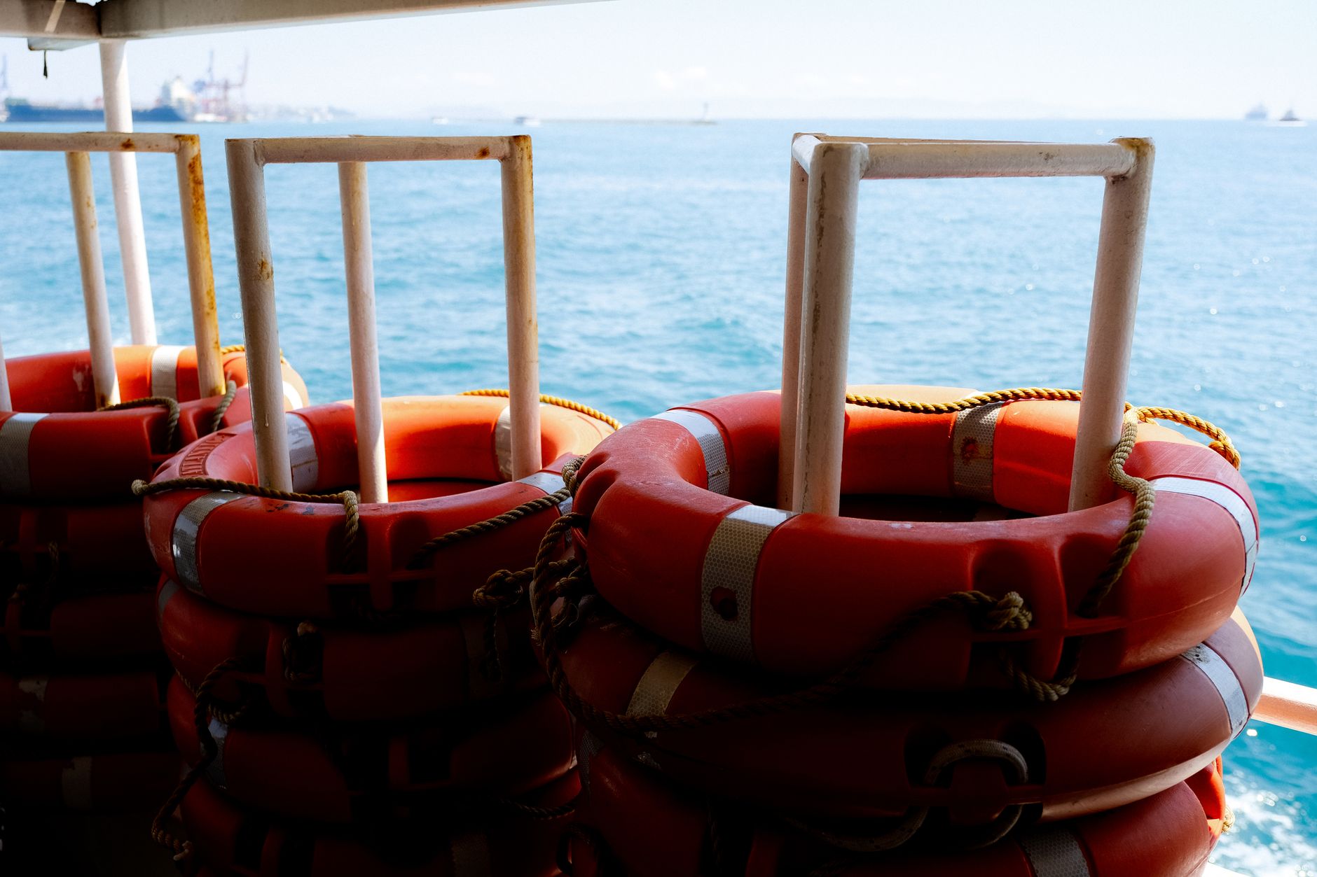 a naval sonar equipment array mounted on a research vessel deck, with calm open-water visible in the background