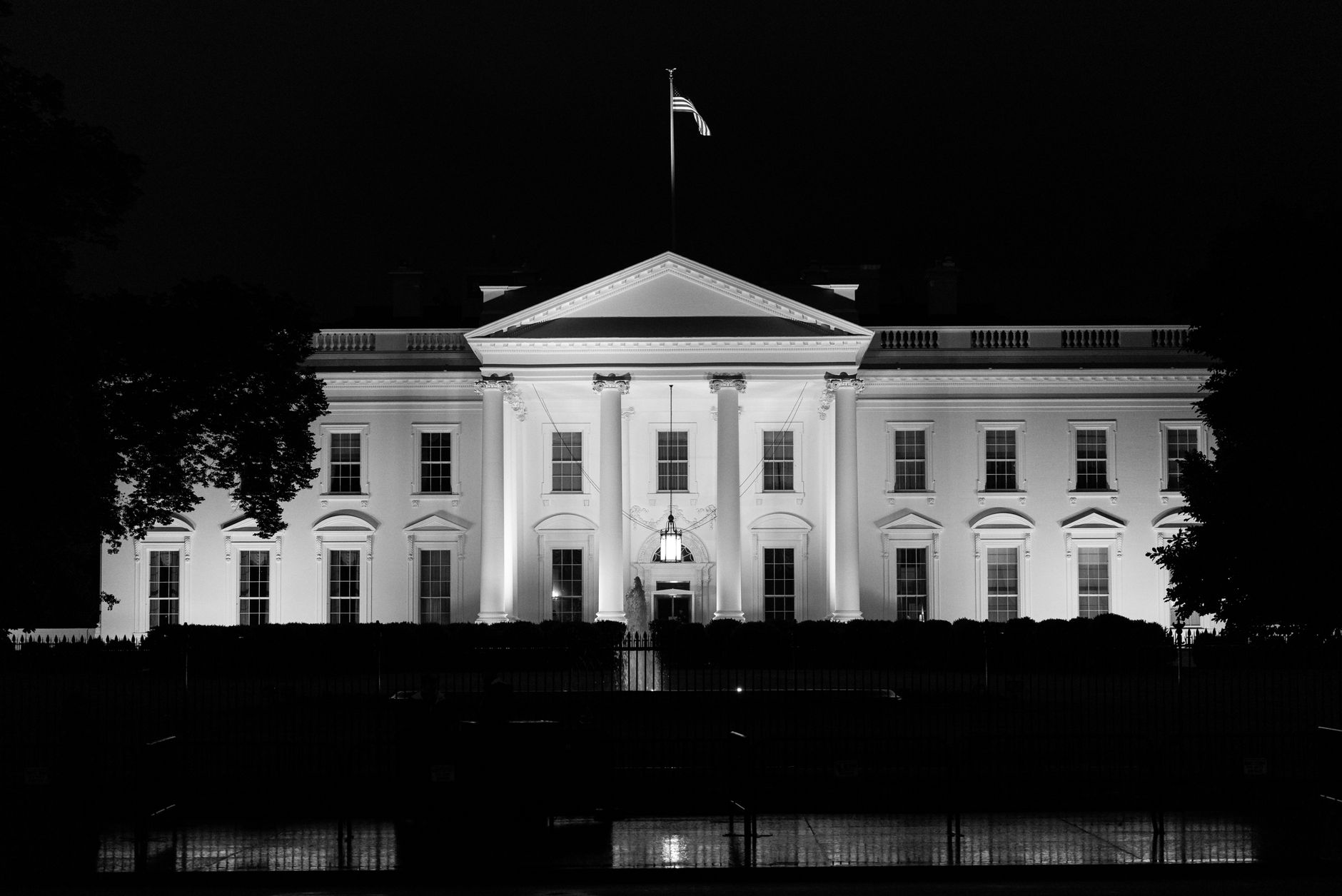 wide exterior shot of the White House South Lawn at dusk, formal reception tents and diplomatic vehicles visible in the background, no people as focal point