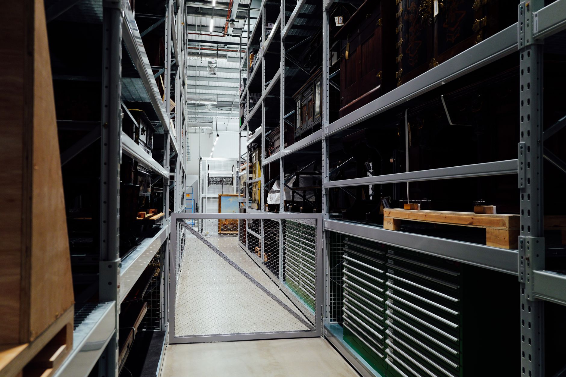 rows of precision-guided munitions on storage racks inside a large military warehouse facility