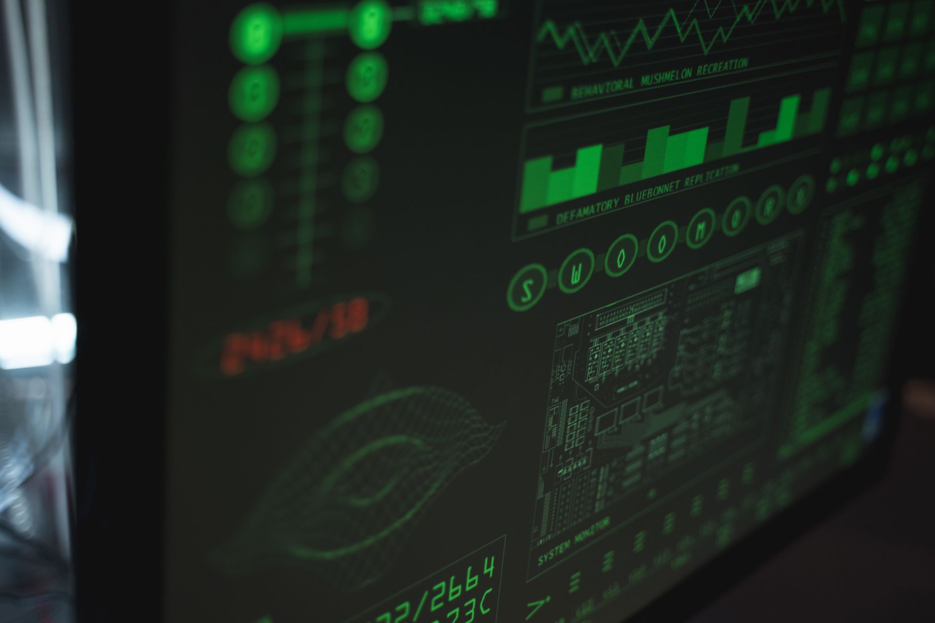 interior of a naval systems integration laboratory with rack-mounted signal processing equipment and large display monitors showing acoustic data visualizations, no personnel in frame