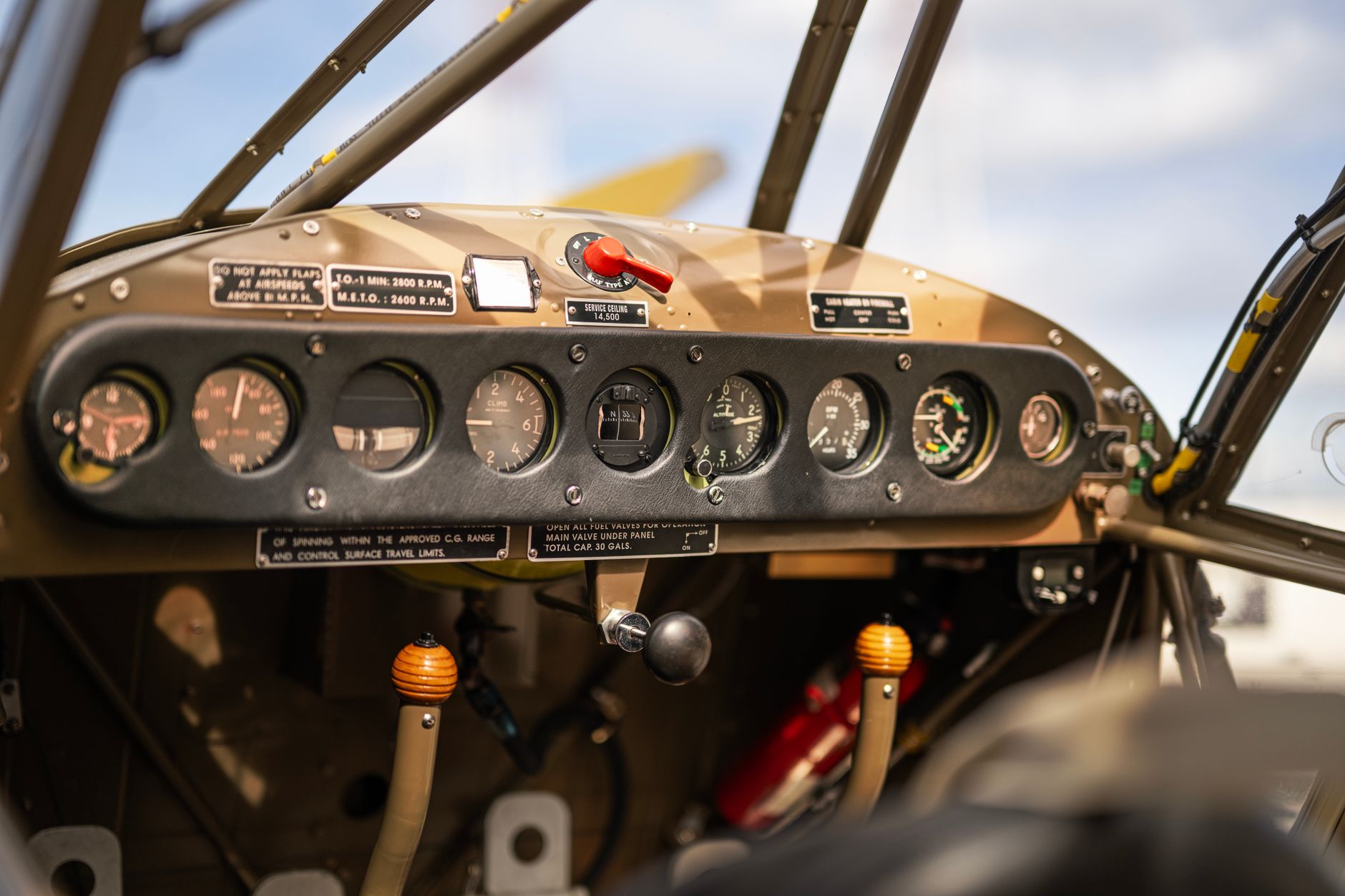 interior view of a B-52 cockpit instrument panel showing rows of analog gauges and modernized digital display inserts, with no crew visible