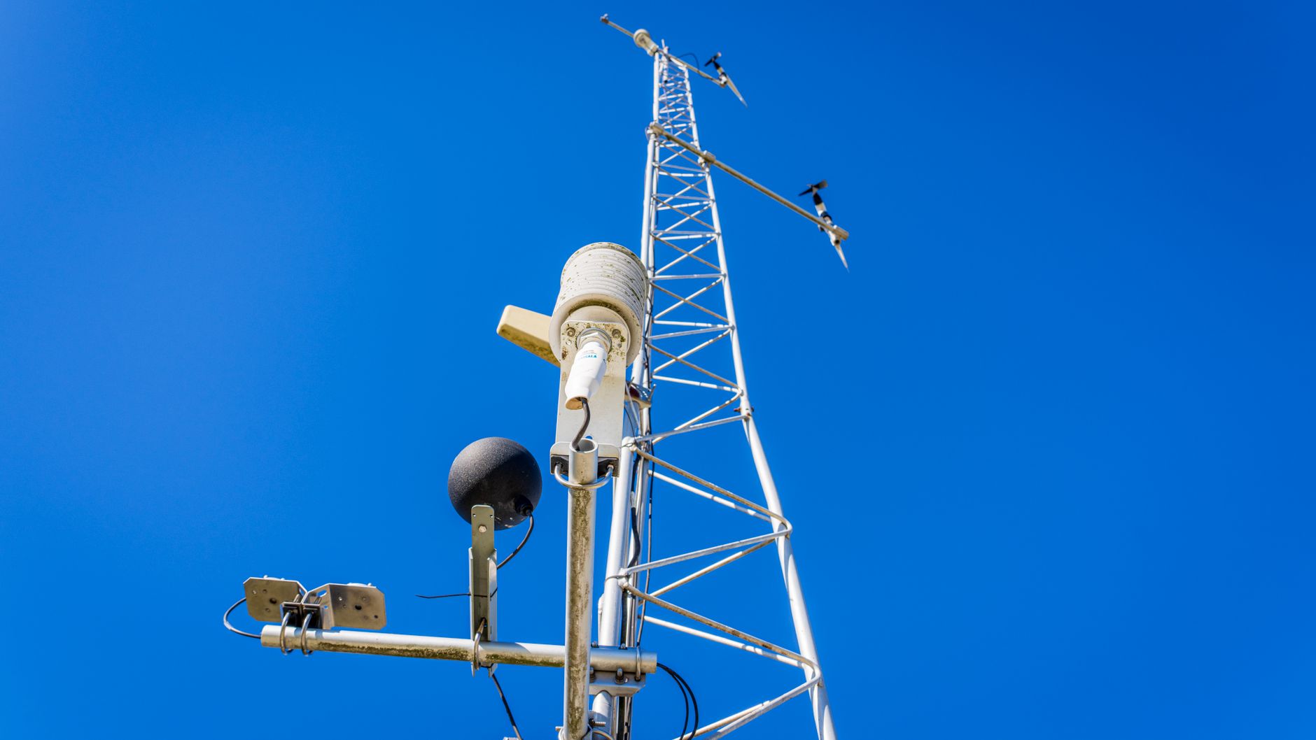 a remote desert test range in central Australia, with launch infrastructure and tracking antenna arrays visible under clear skies