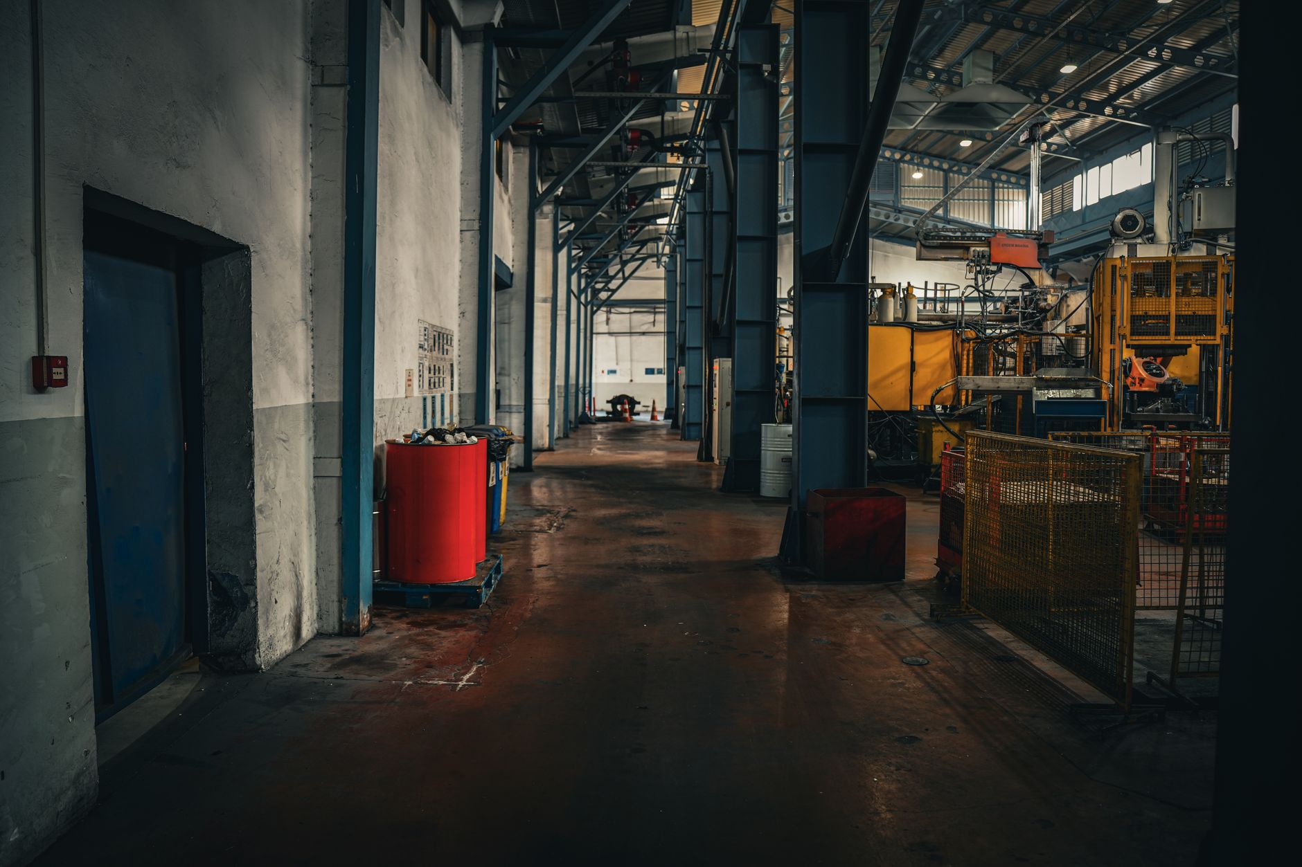 rows of aerospace propulsion test components inside a large industrial assembly facility, with high-bay ceilings and overhead cranes visible
