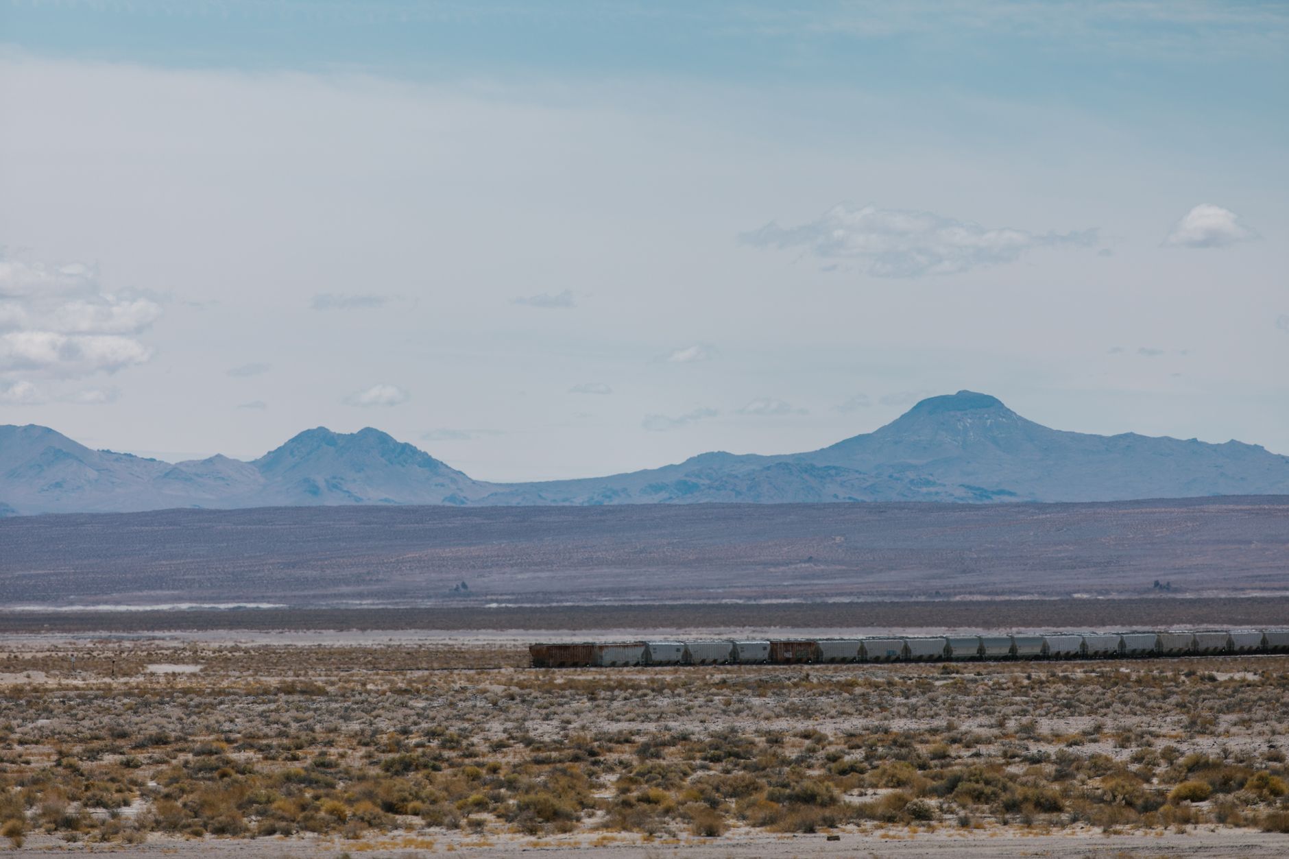a Soviet-era surface-to-air missile battery positioned in an open desert landscape, launch rails elevated toward a pale sky