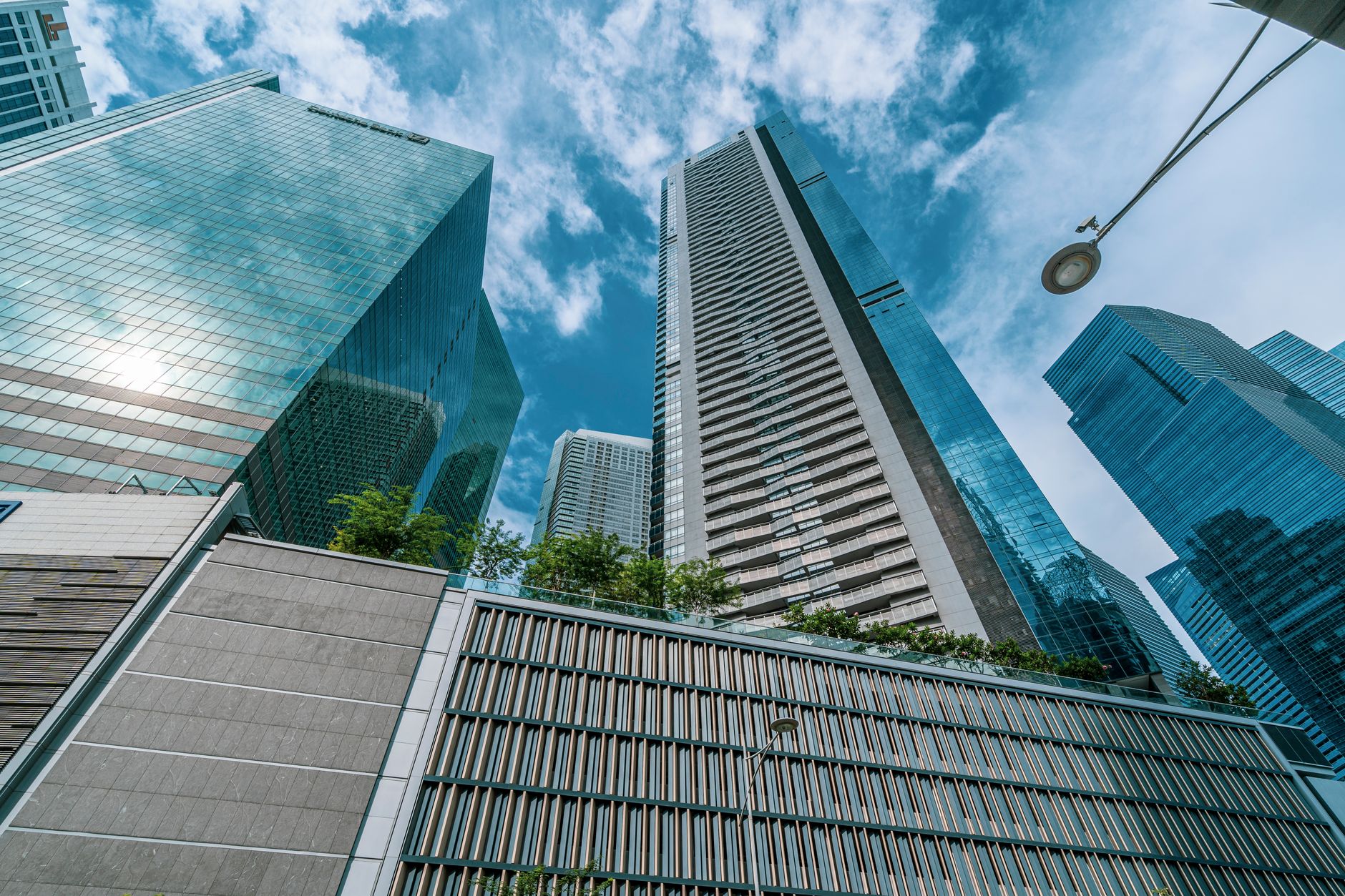 a modern high-technology office campus with glass buildings and satellite dishes, set against an urban skyline, shot from a wide exterior angle